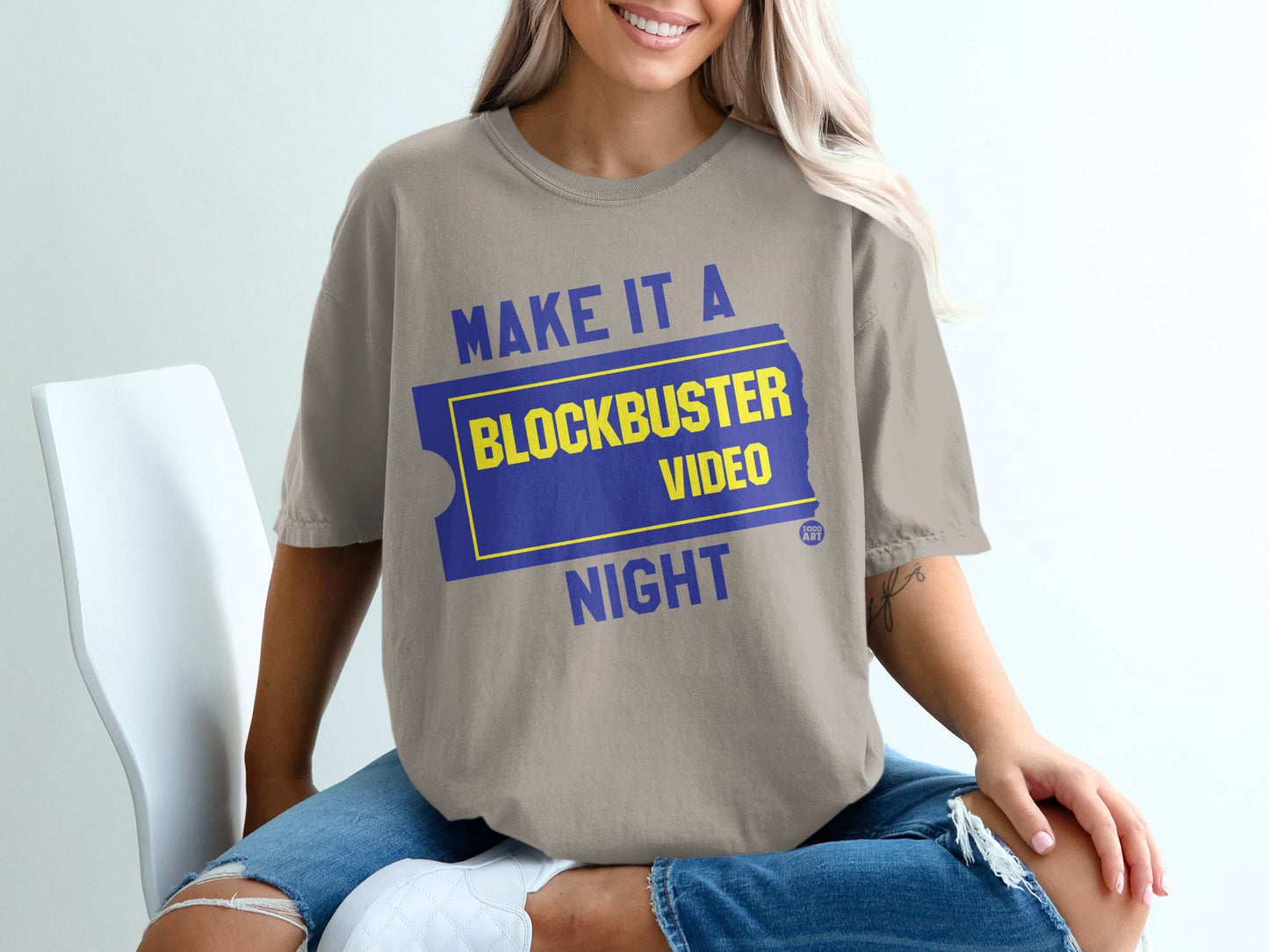 T-shirt with "Make it a Blockbuster Night" text on a ticket graphic.