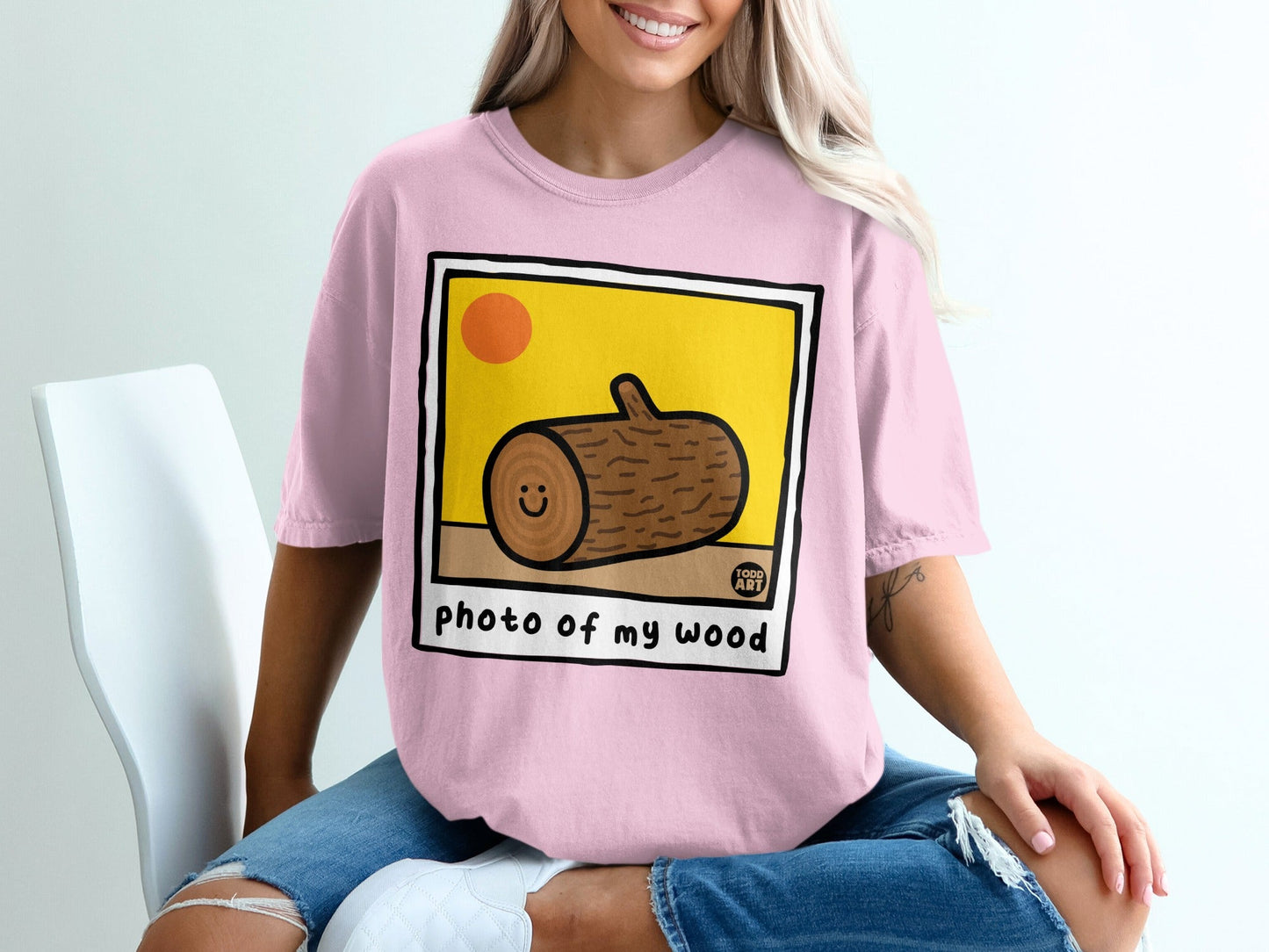 Pink t-shirt with cartoon log and text "photo of my wood".