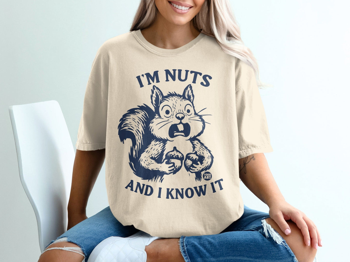 Cream t-shirt with surprised squirrel graphic and text "I'M NUTS AND I KNOW IT".