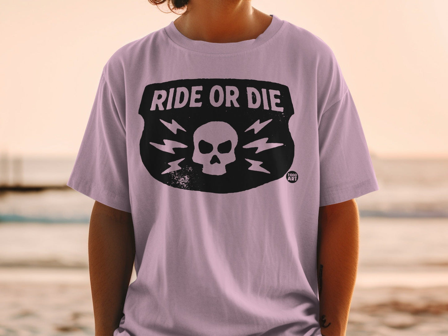 T-shirt with "RIDE OR DIE" and skull graphic on chest.