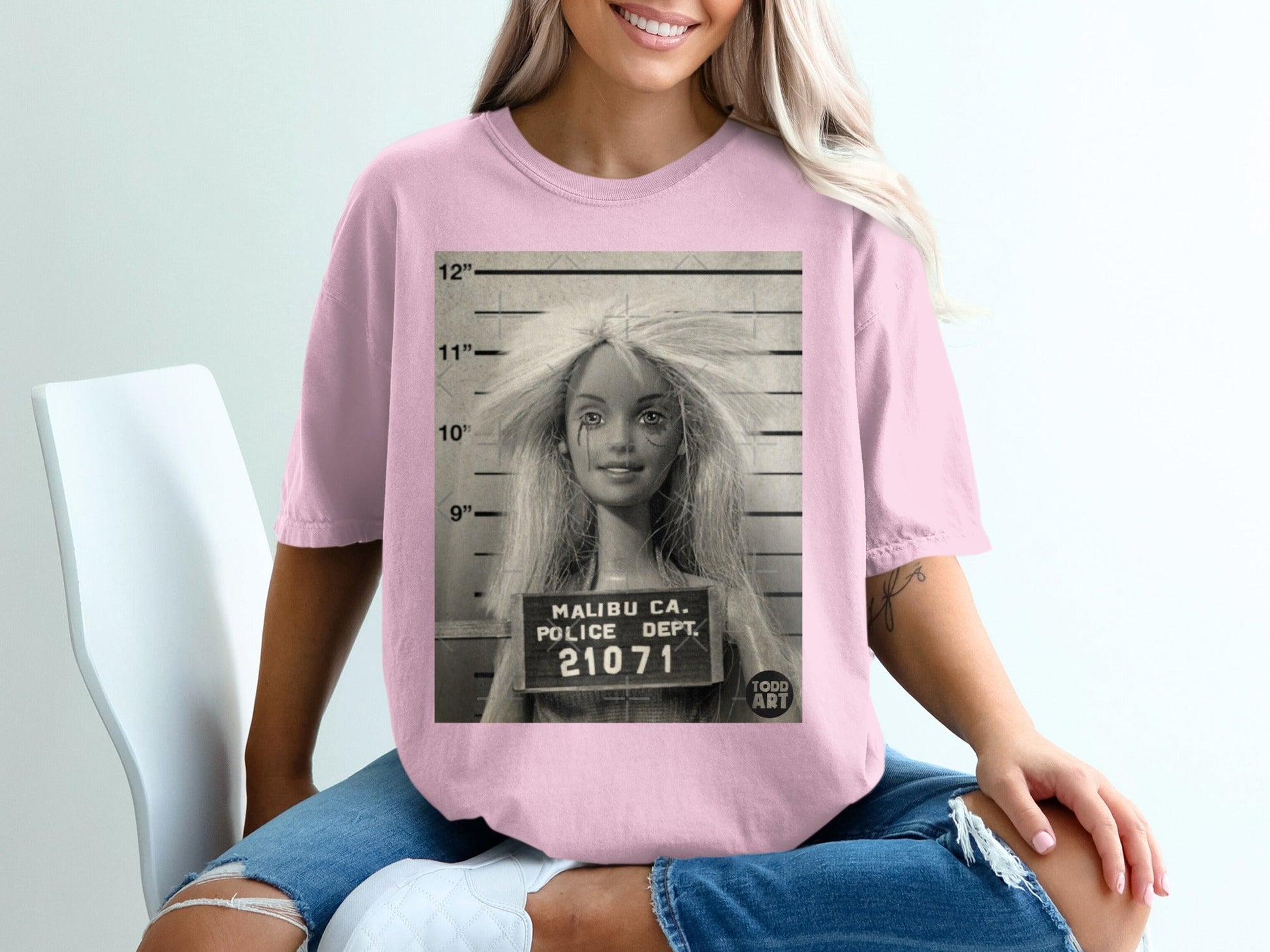 Barbie mugshot with "MALIBU CA. POLICE DEPT. 21071" and "TODD ART" text.