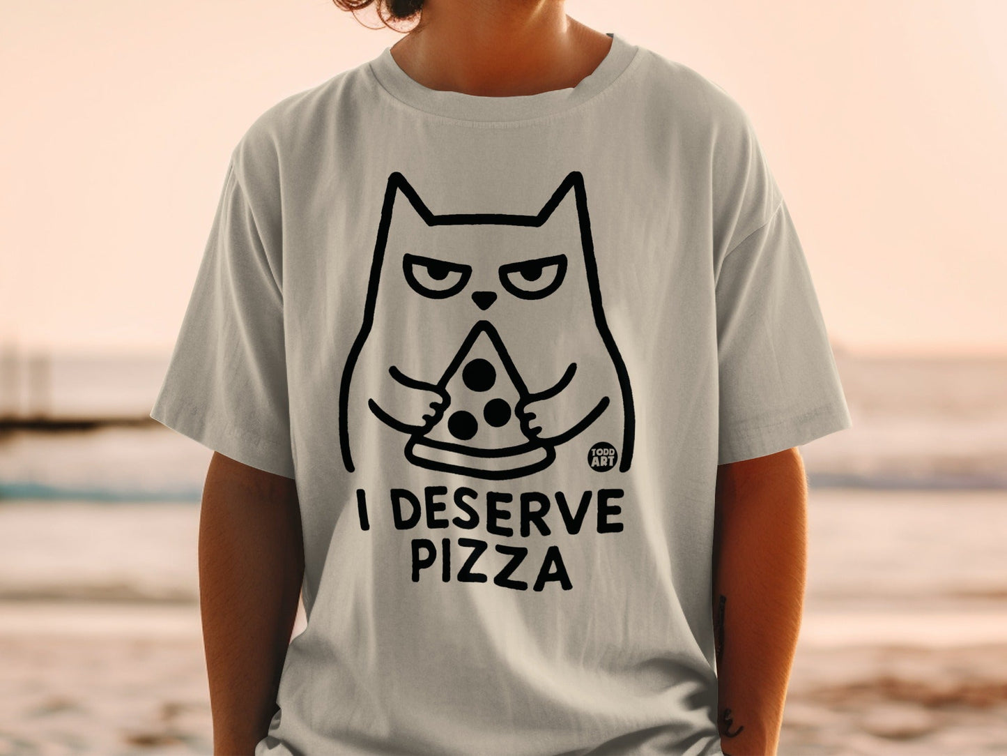 Gray t-shirt with black cat holding pizza and text "I DESERVE PIZZA".