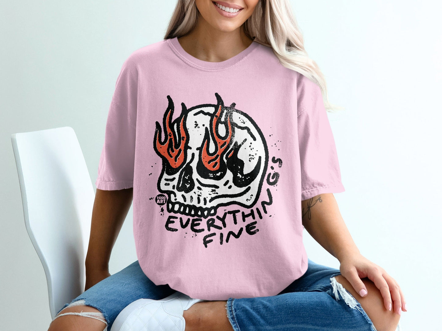 Pink t-shirt with a flaming skull graphic and "EVERYTHIN FINE" text.