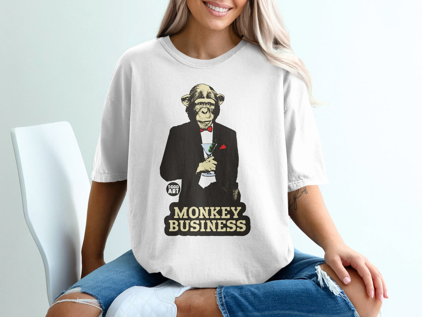 Monkey in tuxedo holding cocktail, "MONKEY BUSINESS" text.