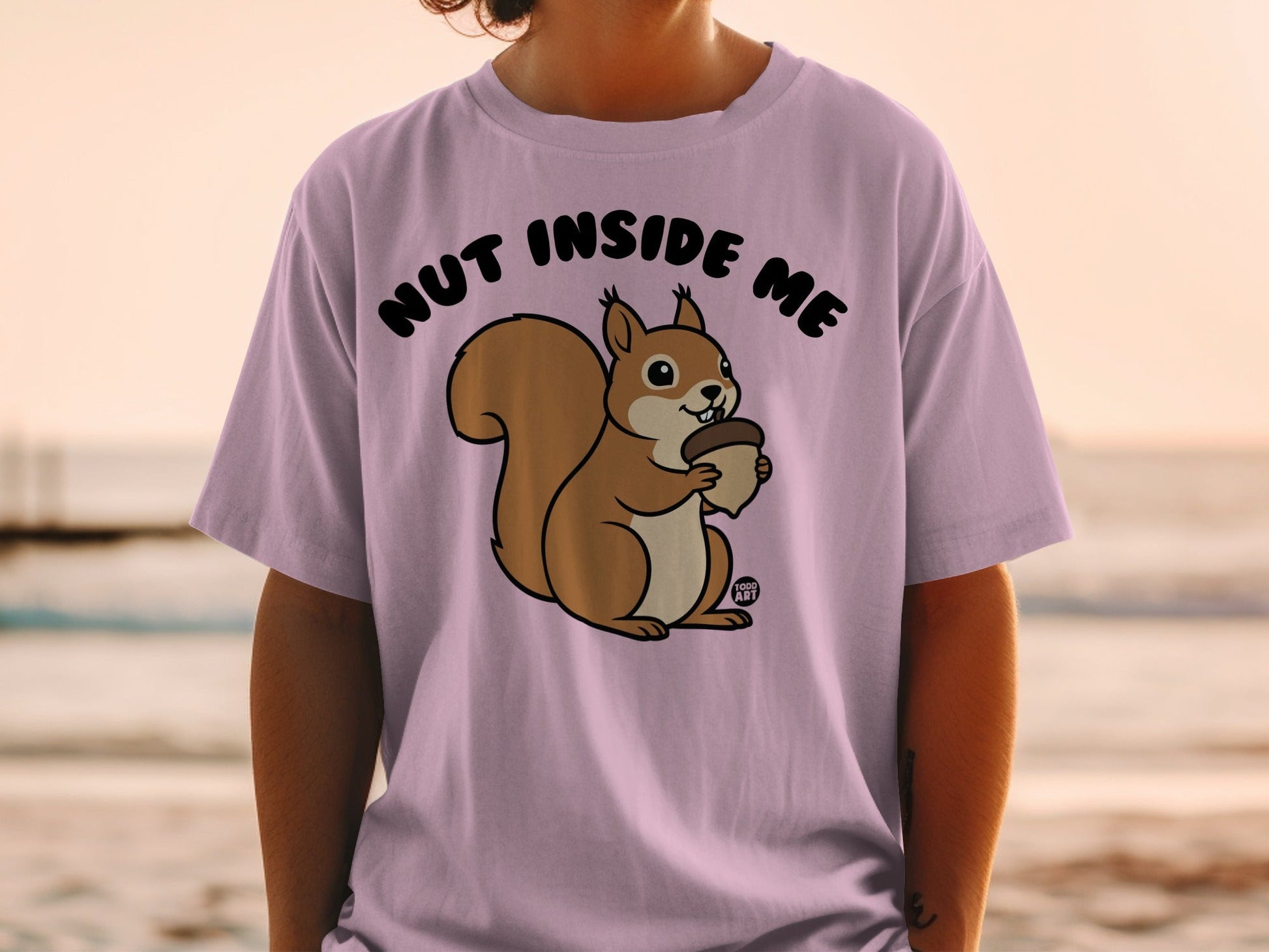 T-shirt with a cartoon squirrel holding a nut and the text "NUT INSIDE ME".