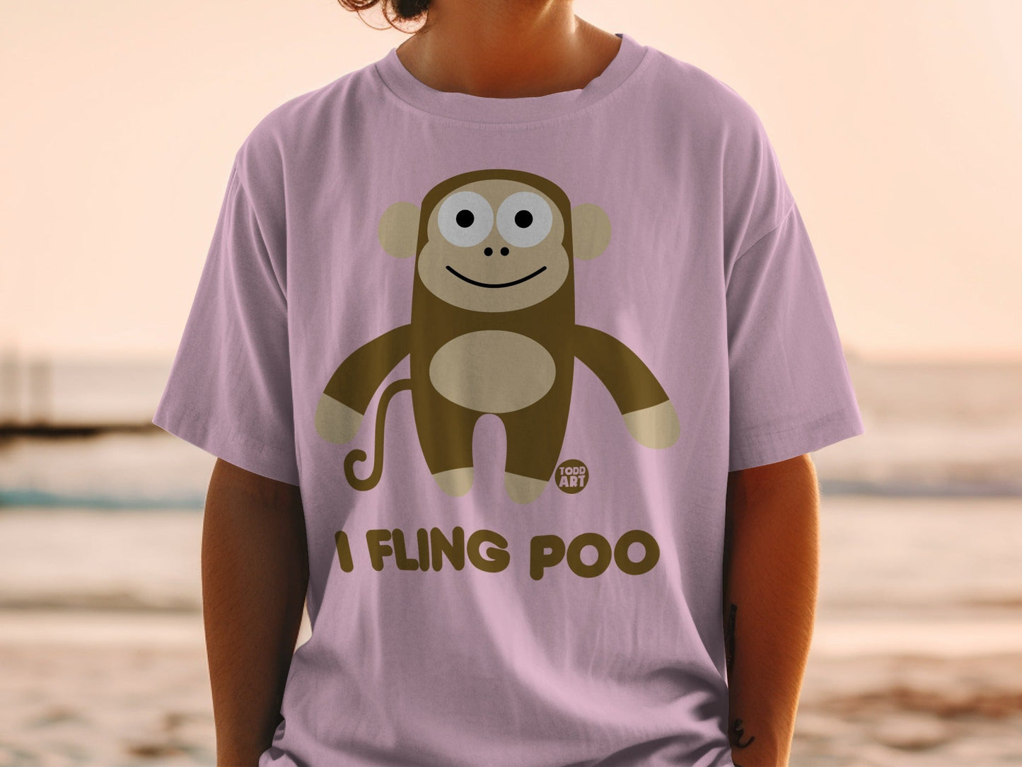 Brown monkey illustration with text "I FLING POO" on a pink t-shirt.