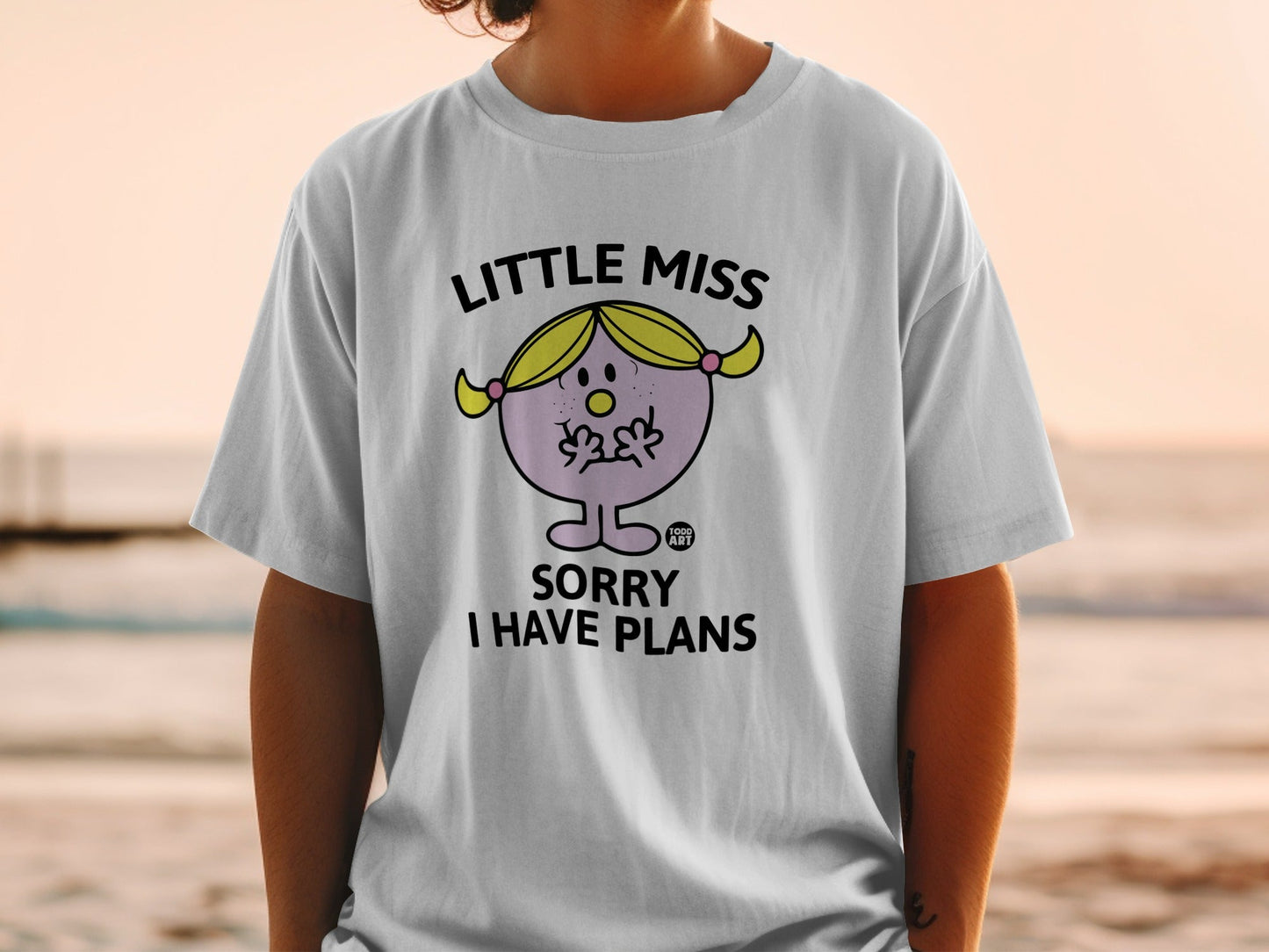 White t-shirt with "Little Miss Sorry I Have Plans" text and cartoon illustration.