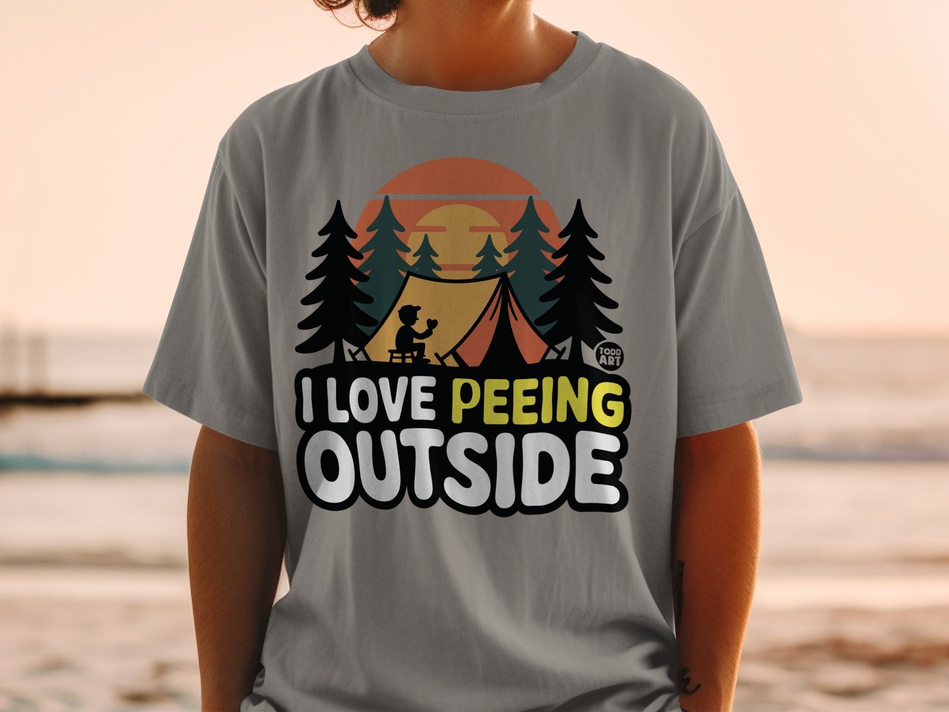 Gray t-shirt with "I LOVE PE**ING OUTSIDE" text and camping graphic.