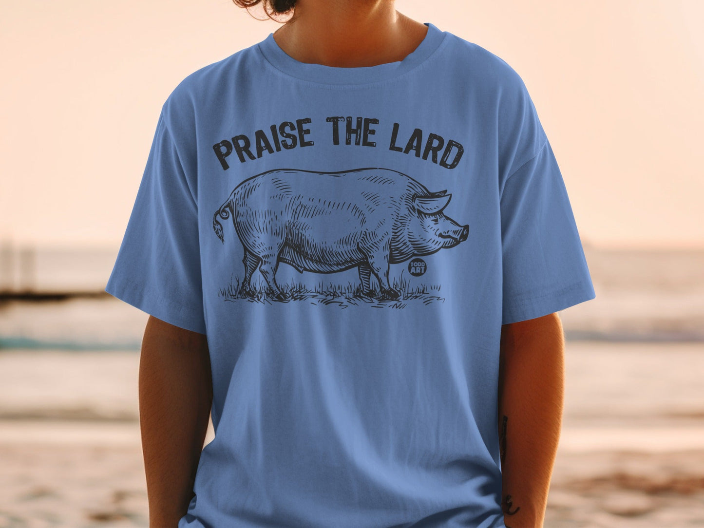 Blue t-shirt with "Praise the Lard" and pig illustration.