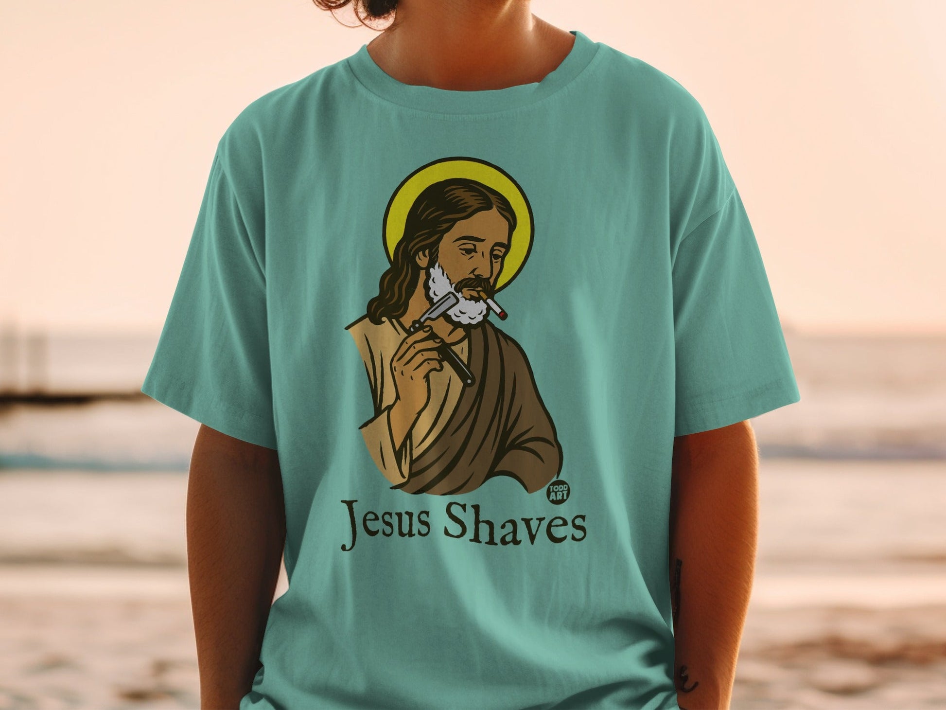 Jesus with halo shaving with a razor, wearing a t-shirt that says "Jesus Shaves".