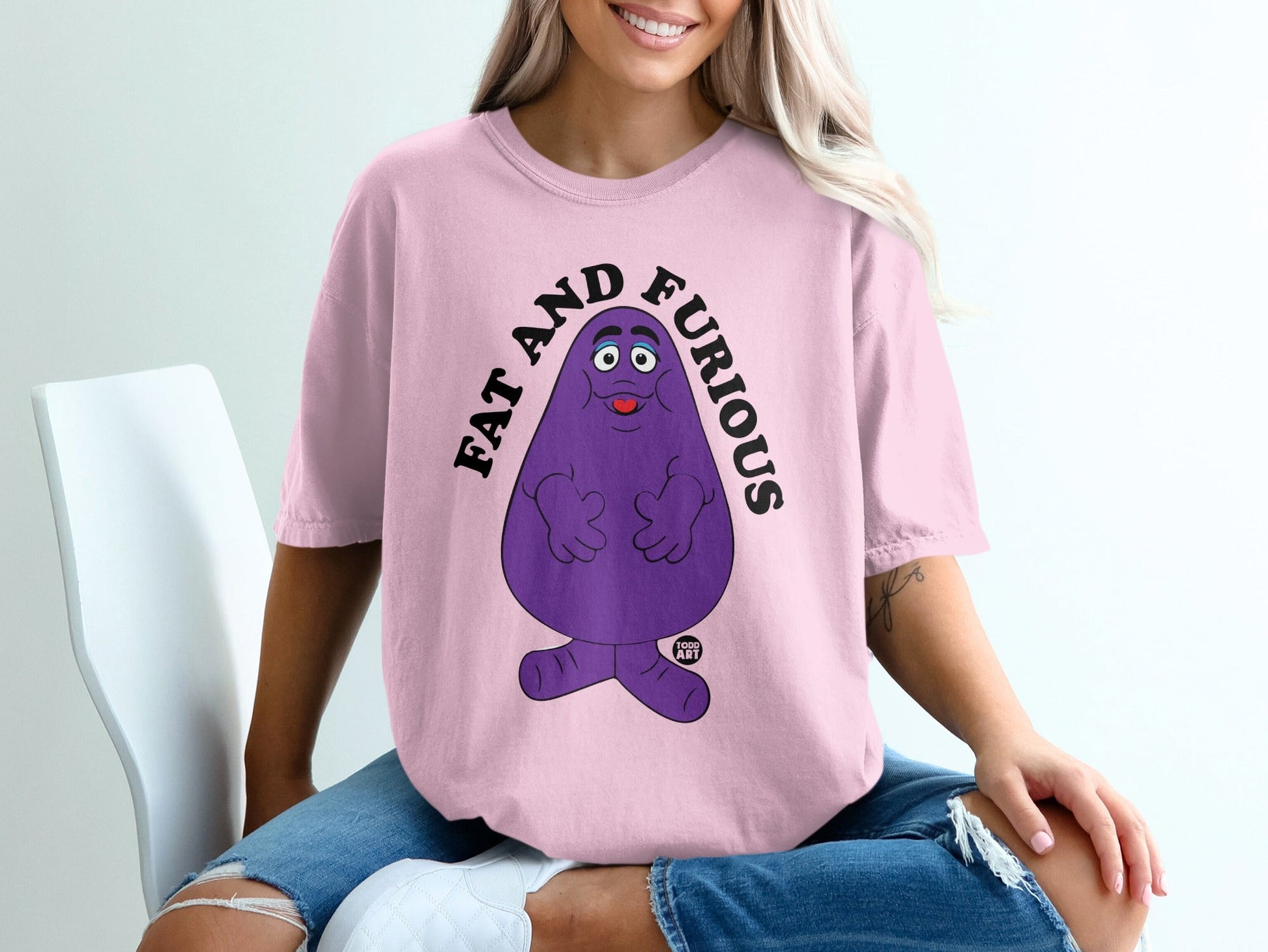 Pink t-shirt with purple Grimace character and text "FAT AND FURIOUS".
