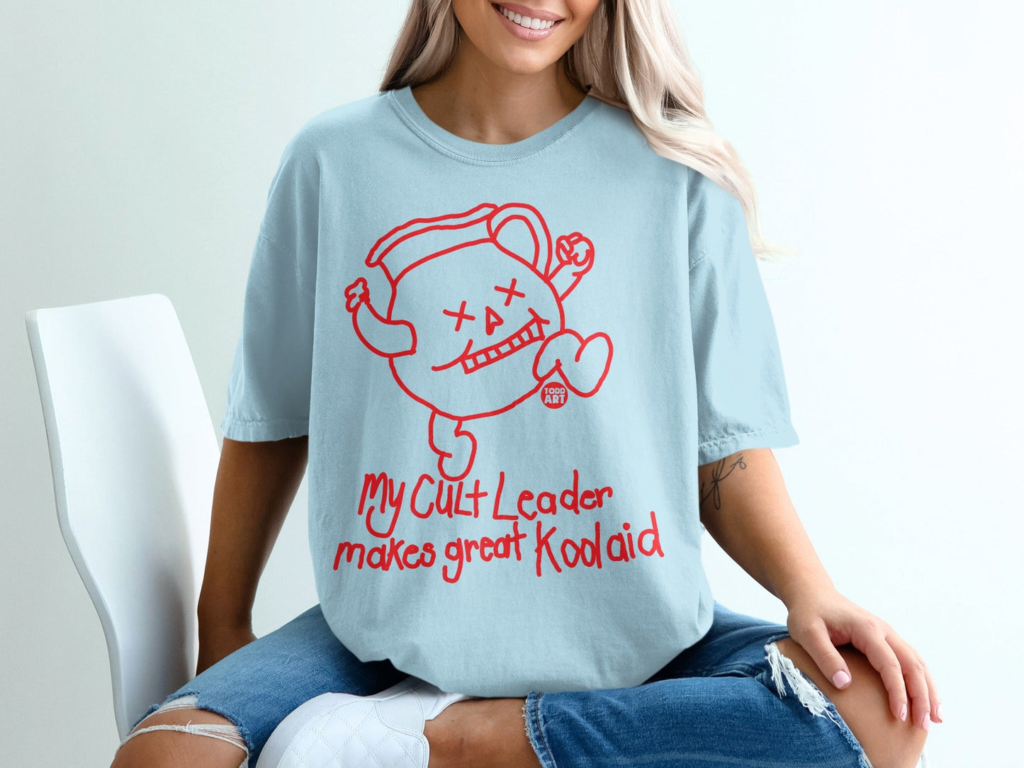 Light blue t-shirt with cartoon Kool-Aid Man graphic and text.