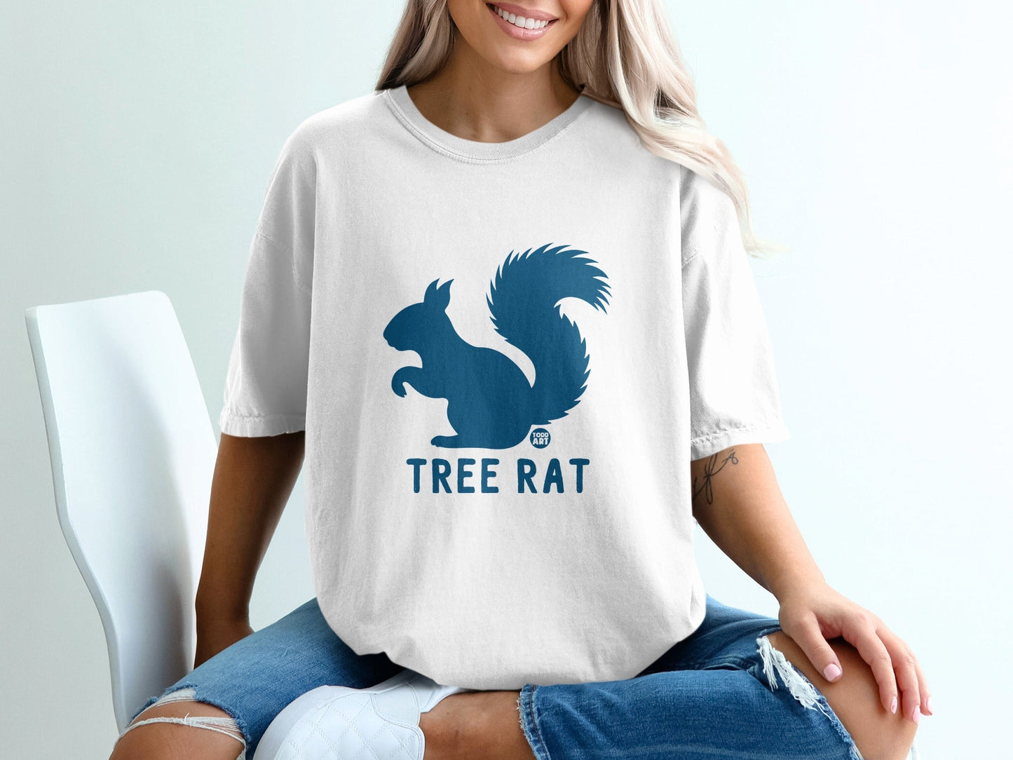 White t-shirt with dark blue squirrel silhouette and "TREE RAT" text.