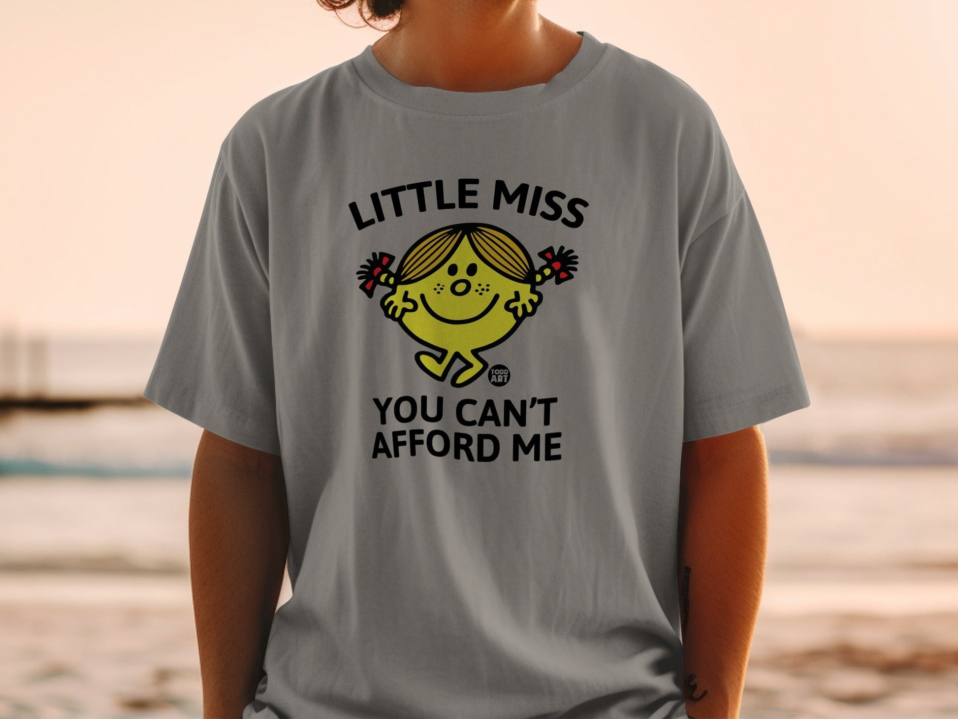Grey t-shirt with "Little Miss You Can't Afford Me" and character graphic.