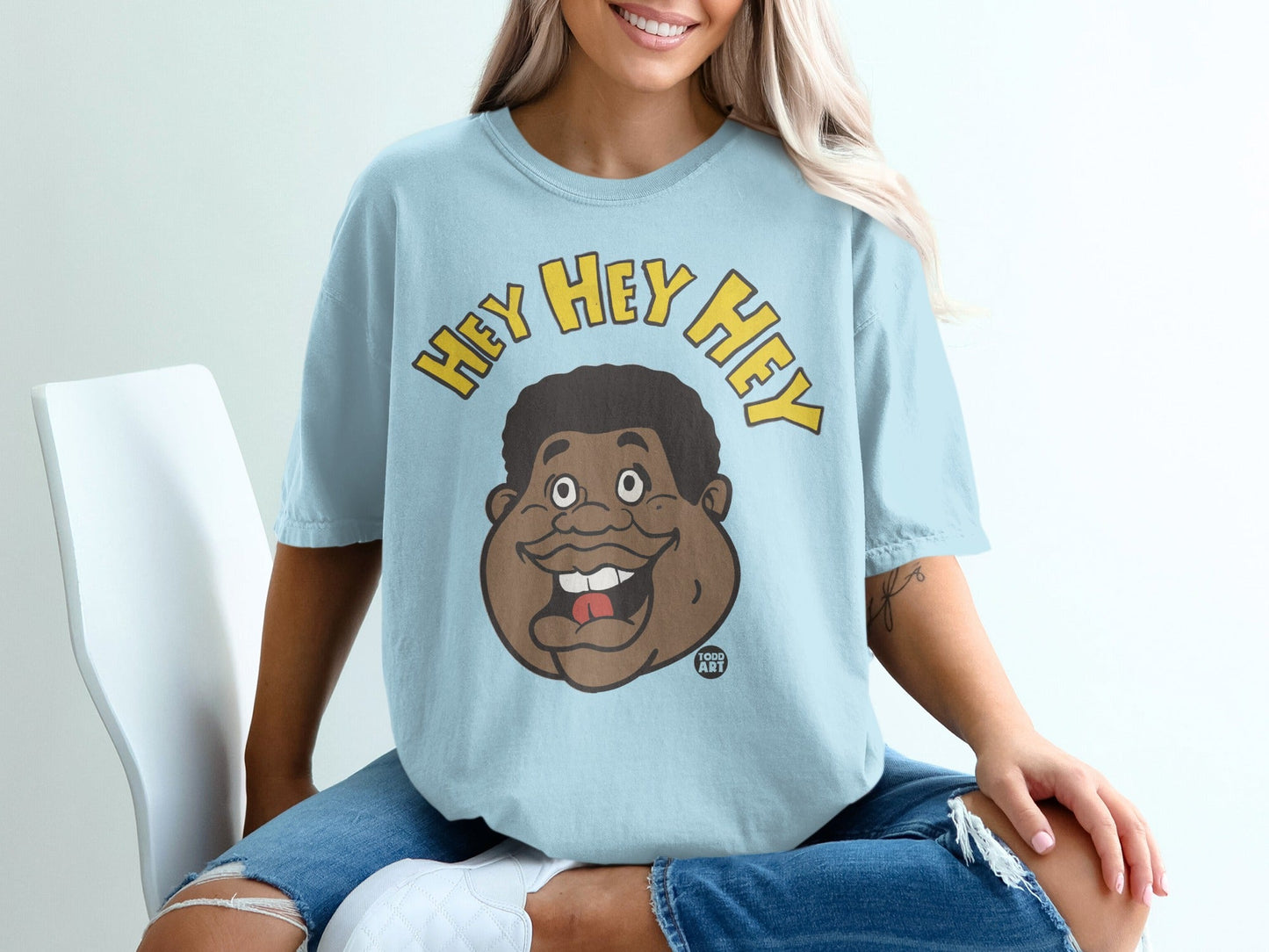 Light blue t-shirt with cartoon face and "HEY HEY HEY" text.