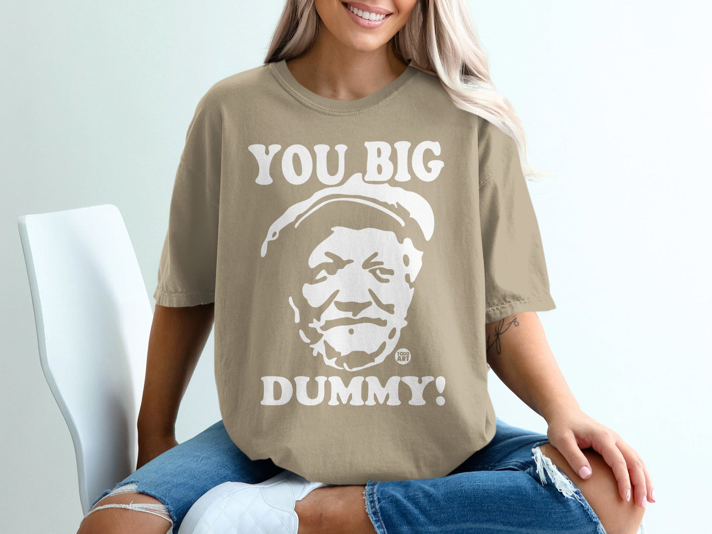 Tan t-shirt with "YOU BIG DUMMY!" and a face graphic.