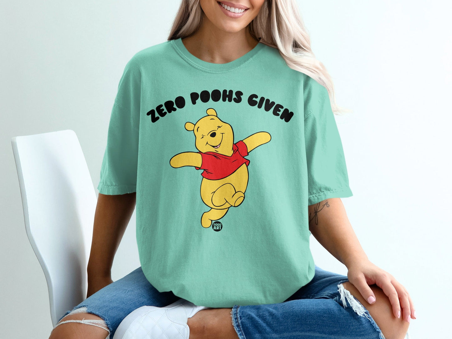 Mint green t-shirt with Winnie the Pooh and "Zero Poohs Given" text.