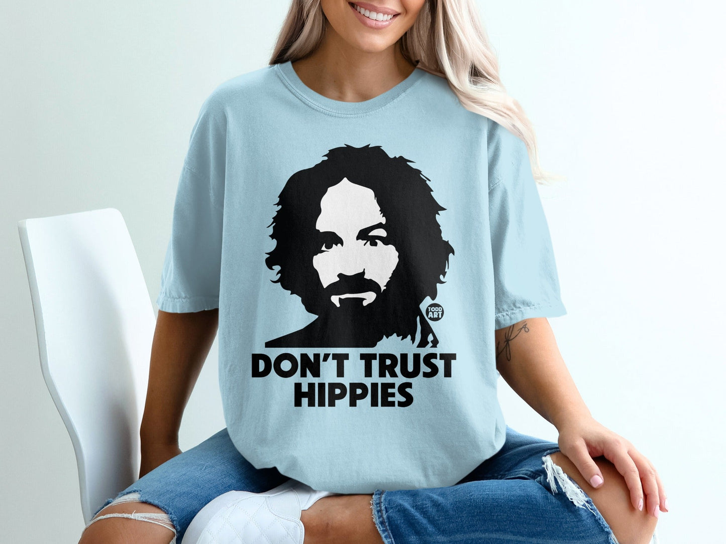 Light blue t-shirt with Charles Manson graphic and "DON'T TRUST HIPPIES" text.