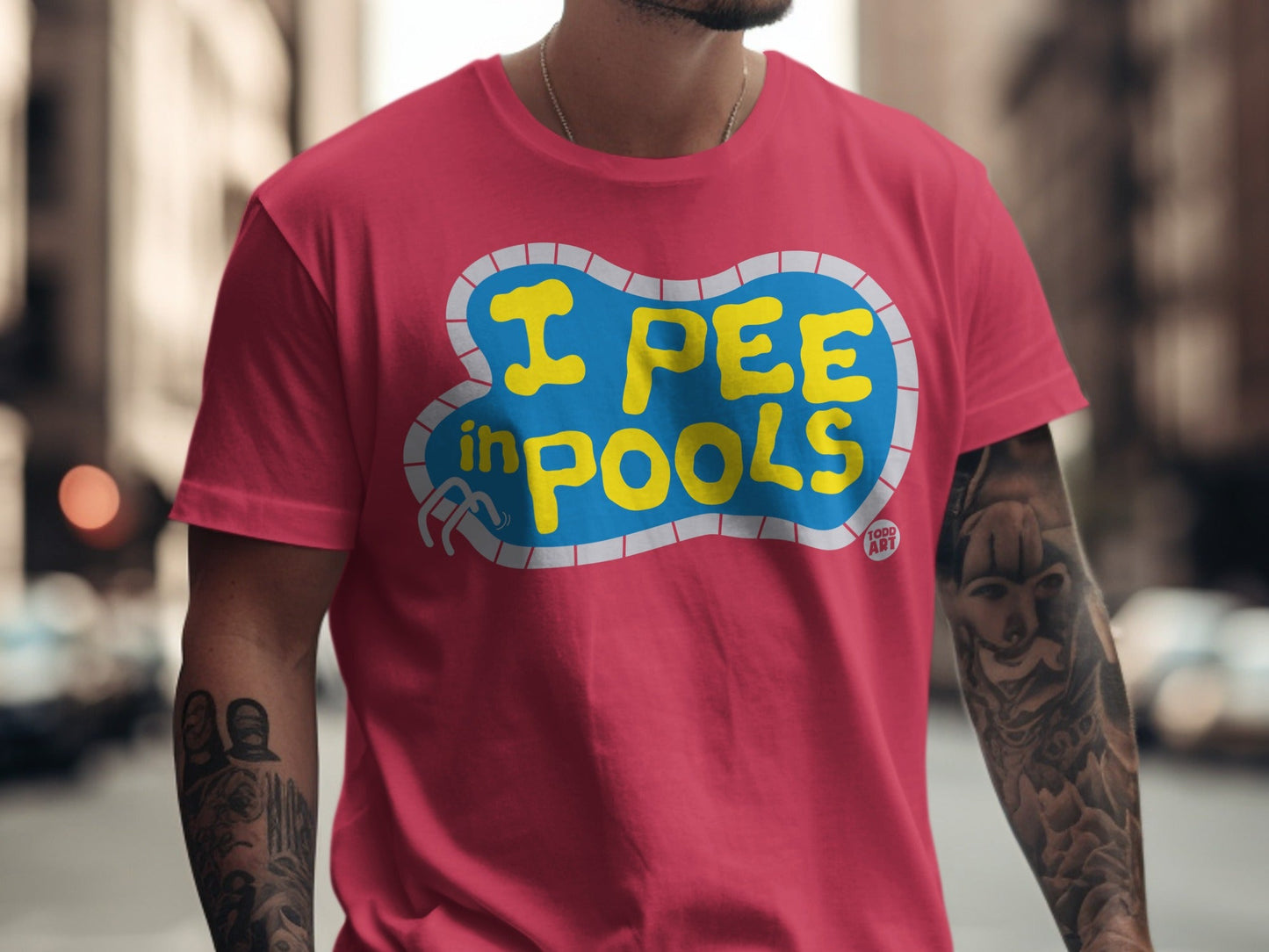 Pink t-shirt with yellow text "I PEE IN POOLS" in a pool shape.