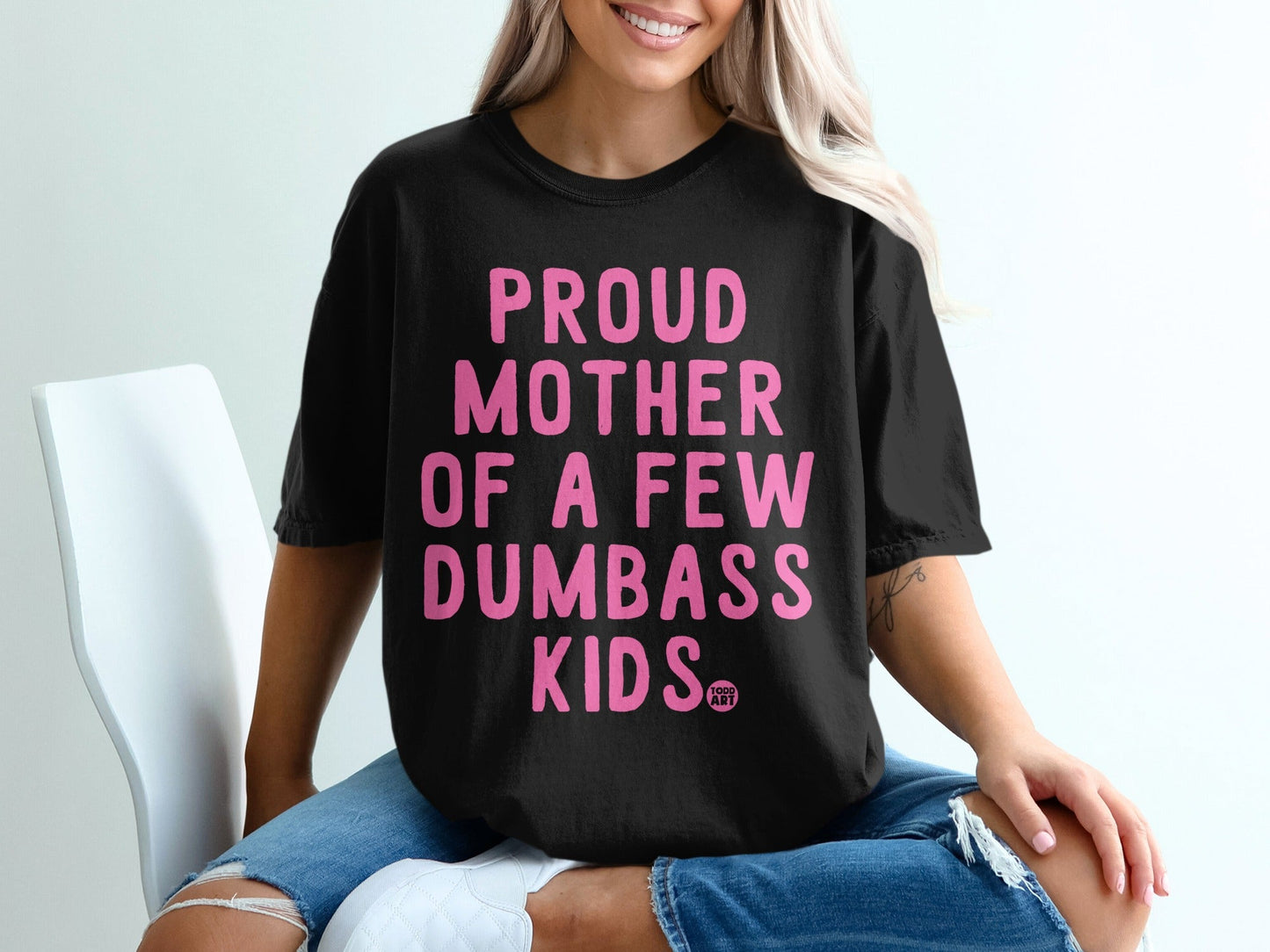 Black t-shirt with "PROUD MOTHER OF A FEW DUMBASS KIDS" in pink text.