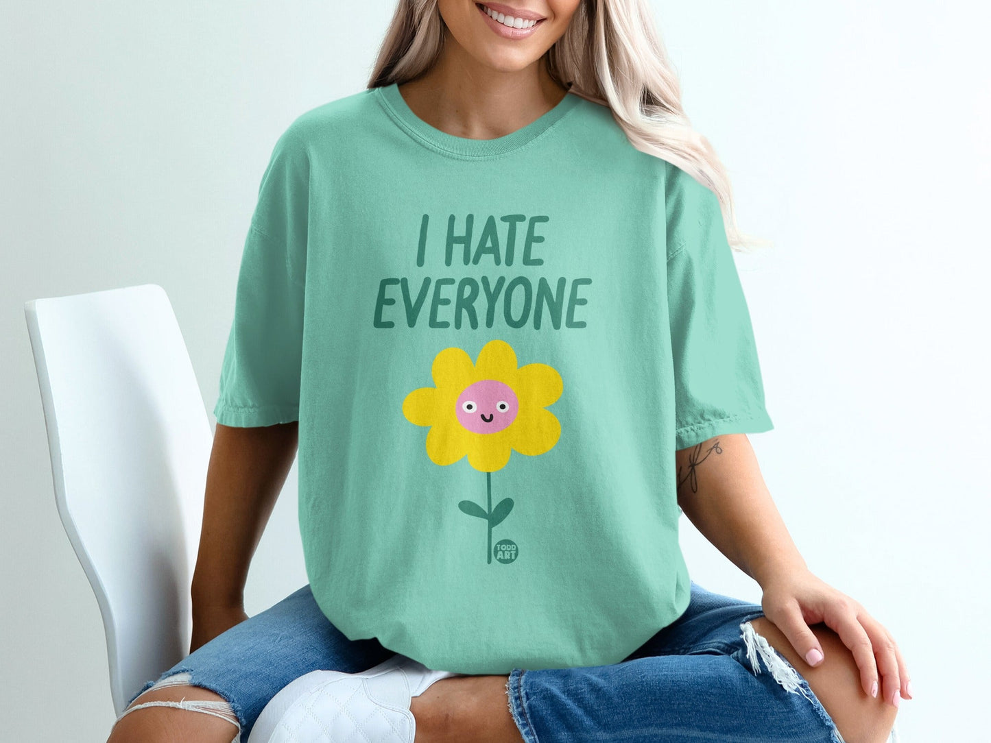 Mint t-shirt with smiling flower and "I HATE EVERYONE" text.