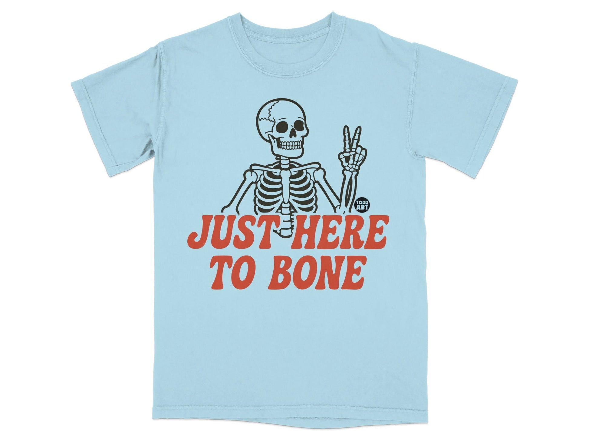 Light blue t-shirt with skeleton giving peace sign and text "JUST HERE TO BONE".