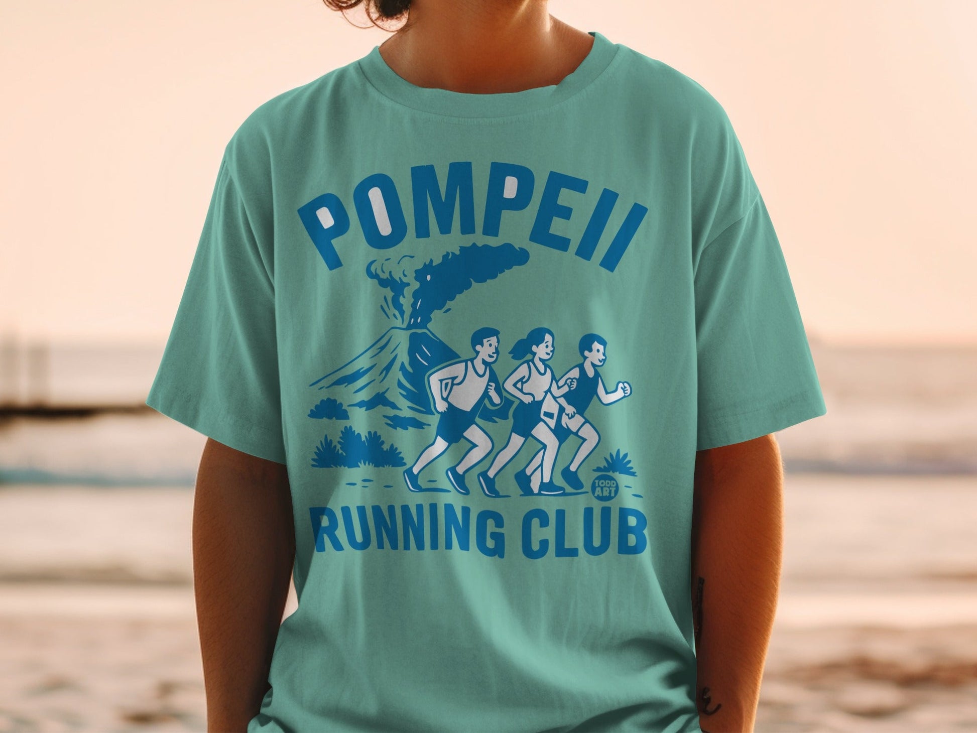 Teal t-shirt with "Pompeii Running Club" text and volcano graphic.