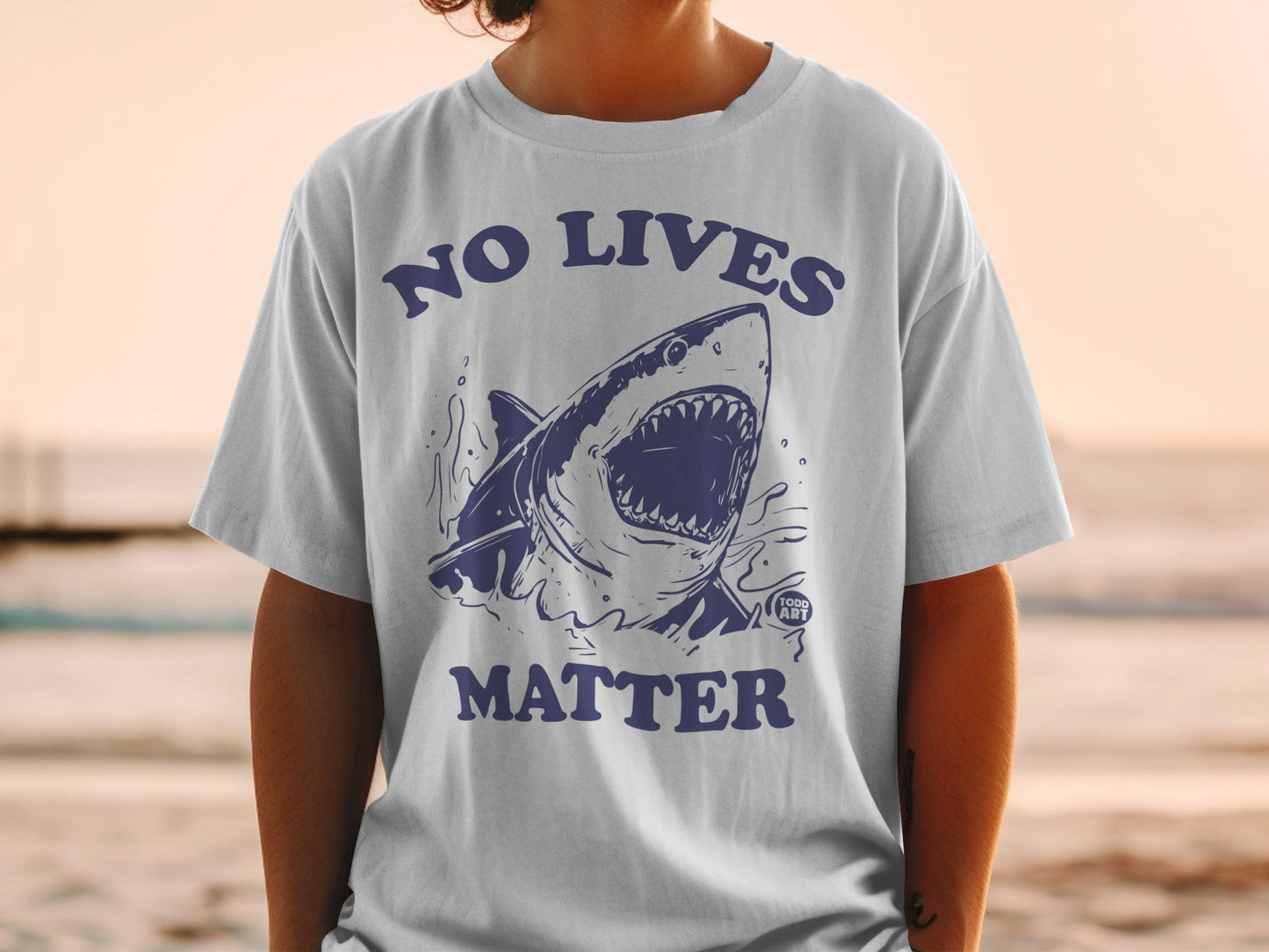 T-shirt with navy blue shark graphic and text "NO LIVES MATTER".