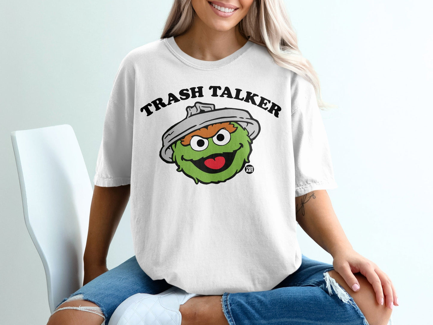 White t-shirt with cartoon monster, "Trash Talker" text.