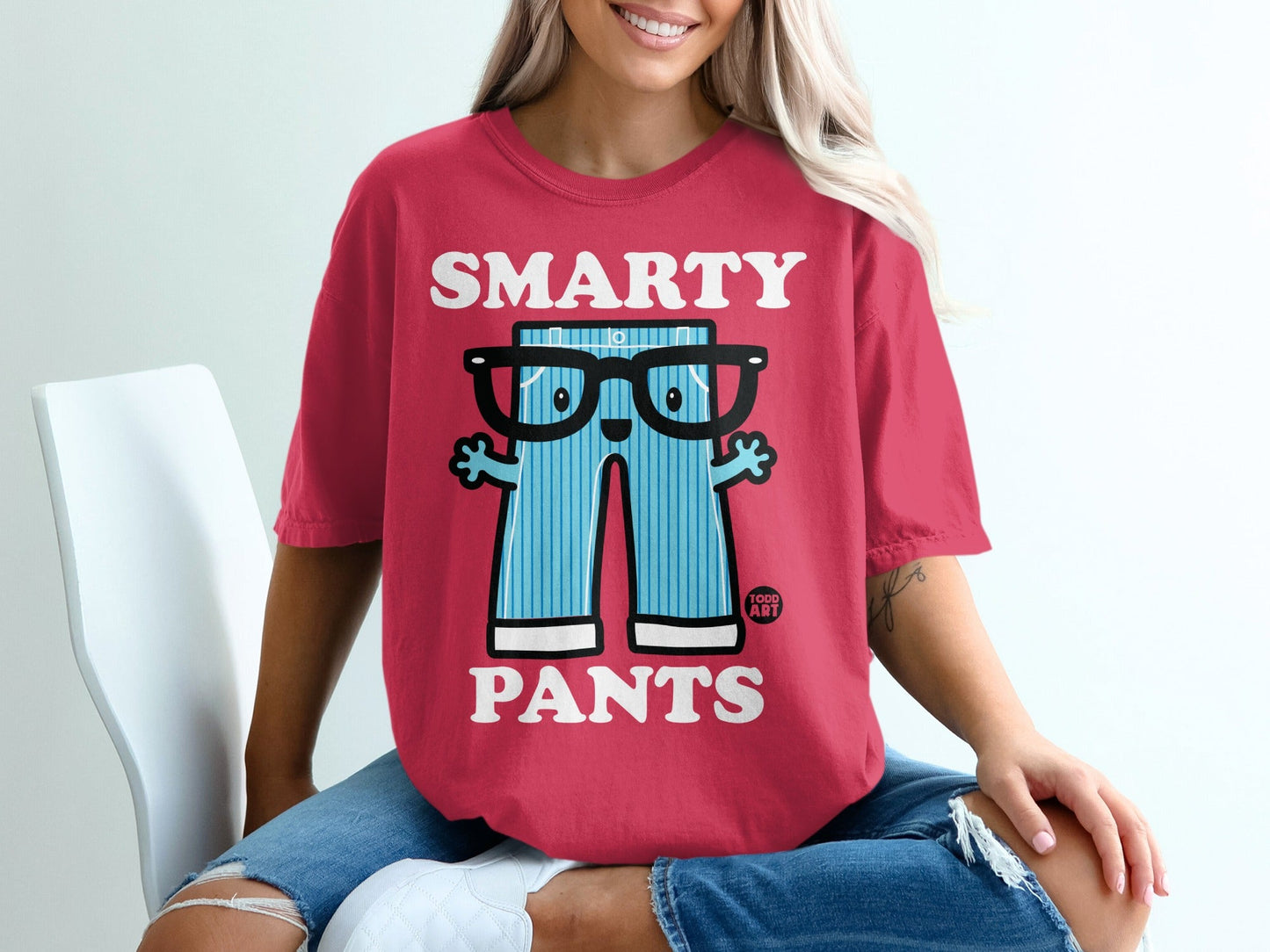 Red t-shirt featuring cartoon smarty pants with glasses and a playful design.
