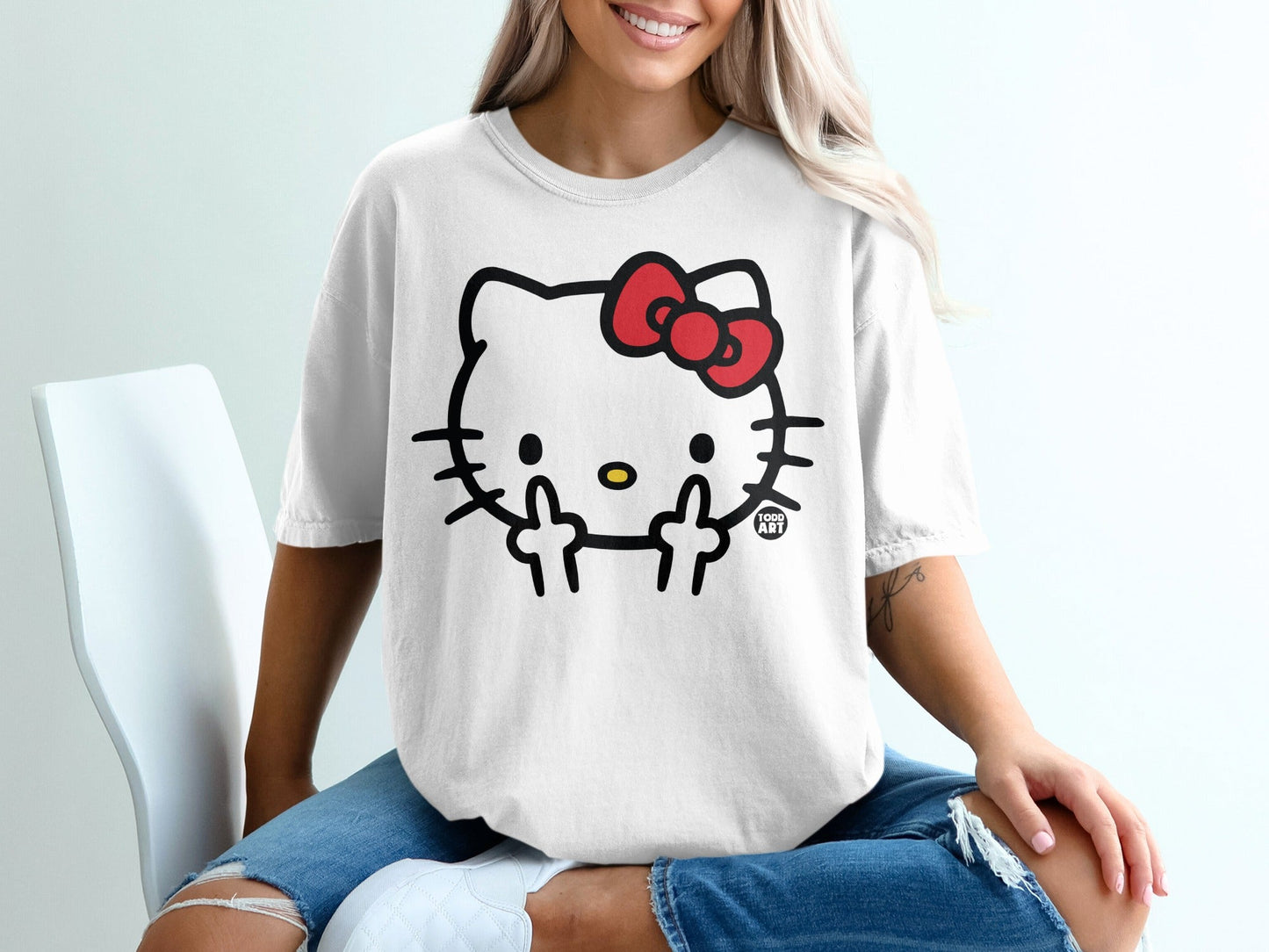 Hello Kitty wearing a red bow gives middle fingers on a white t-shirt.