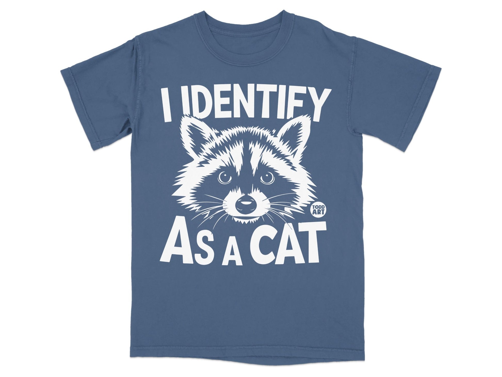 Blue t-shirt with white text "I IDENTIFY AS A CAT" and a raccoon illustration.