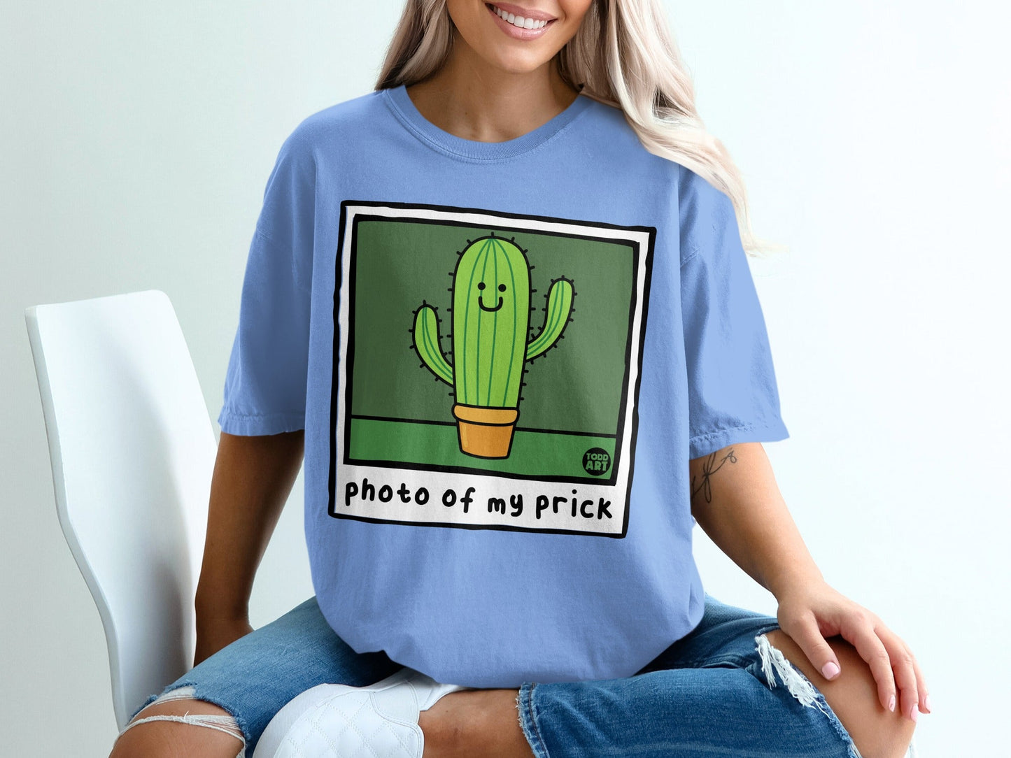 Blue t-shirt with smiling cartoon cactus graphic saying "photo of my prick".