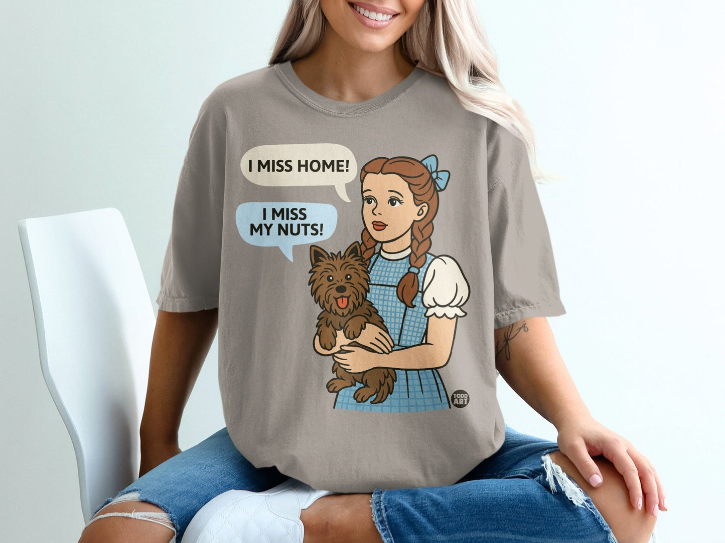 Dorothy holding Toto, with speech bubbles saying "I miss home!" and "I miss my nuts!".