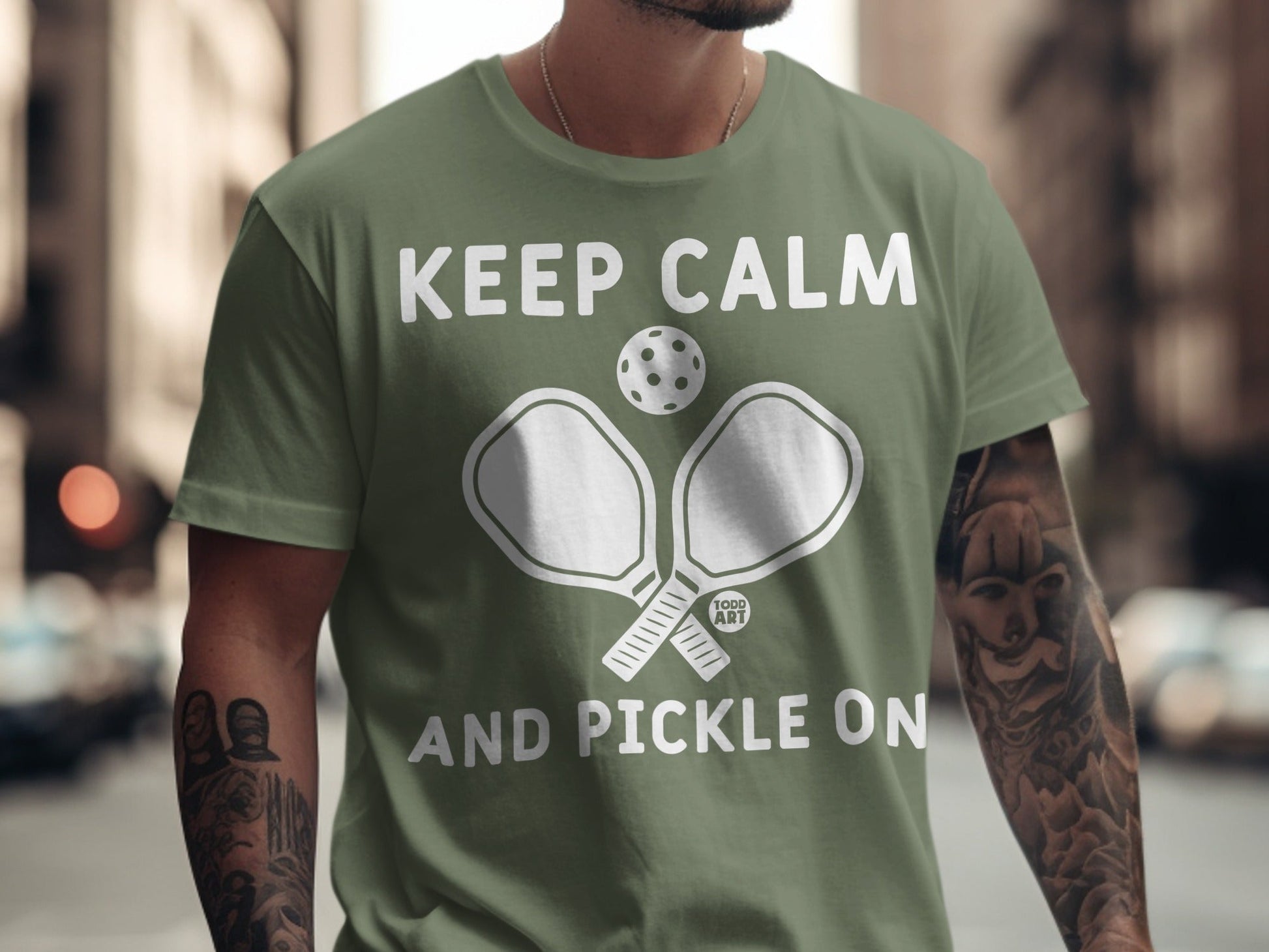 Green t-shirt with "Keep Calm and Pickle On" and pickleball paddles graphic.