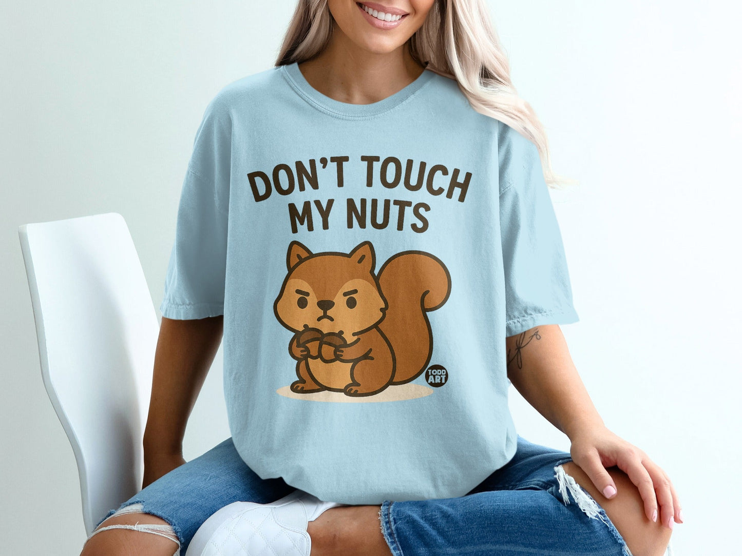 Light blue t-shirt with cartoon squirrel saying "DON'T TOUCH MY NUTS".