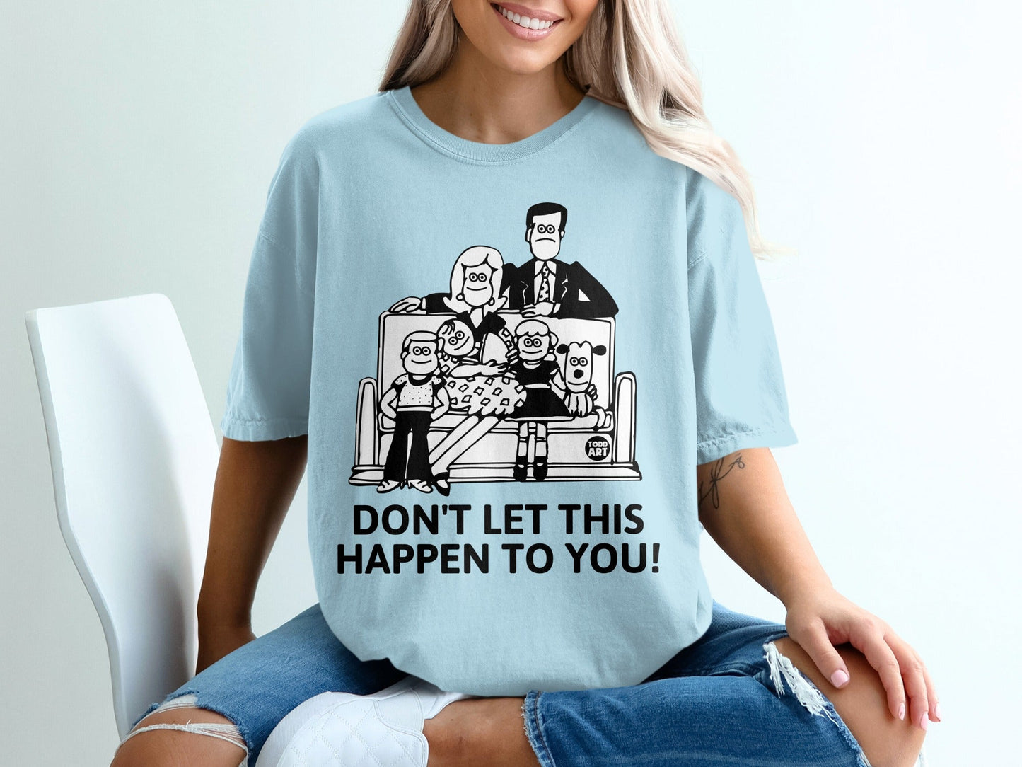 T-shirt with cartoon family on couch and "DON'T LET THIS HAPPEN TO YOU!" text.