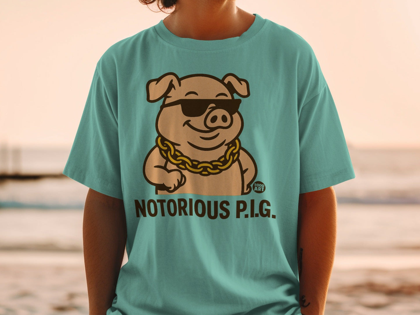Cartoon pig in sunglasses and gold chain, text "NOTORIOUS P.I.G.".