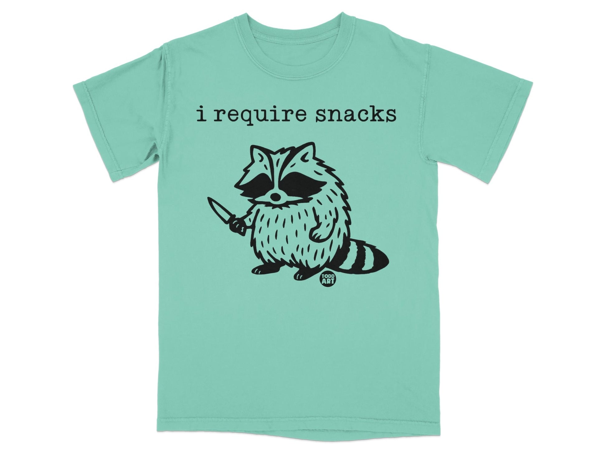 T-shirt with a raccoon holding a knife and the text "i require snacks".