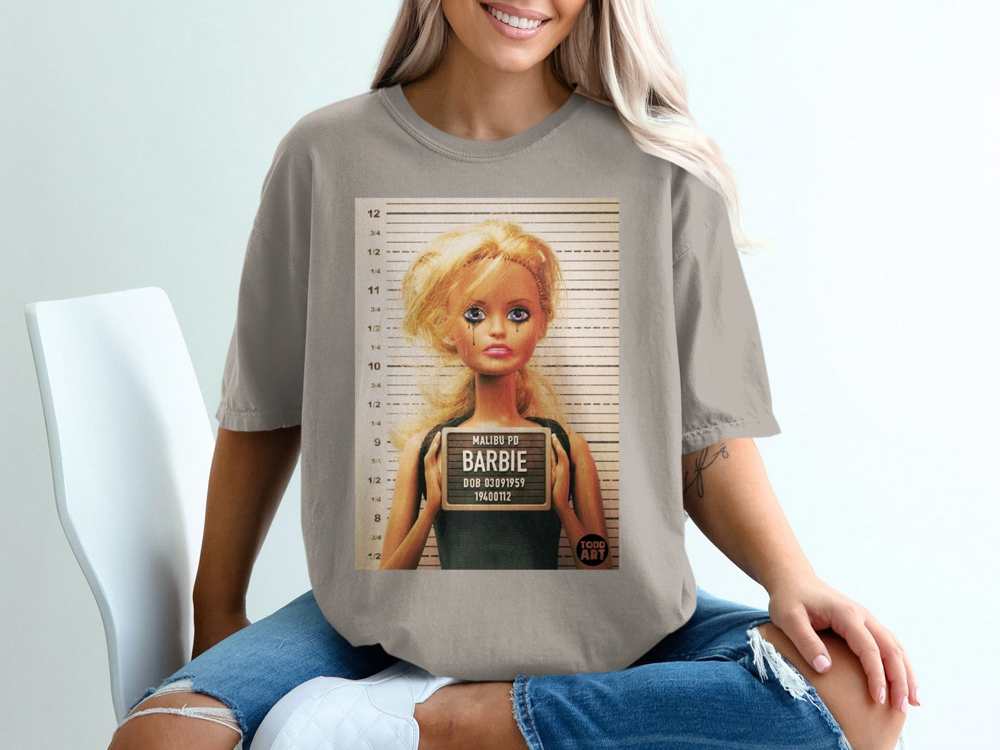 T-shirt with Barbie mugshot: "Malibu PD Barbie", DOB 03091959, 19400112.