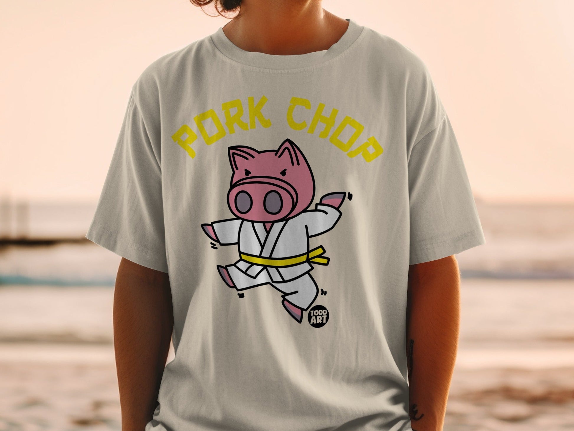 Cartoon pig wearing a gi with "PORK CHOP" text above.