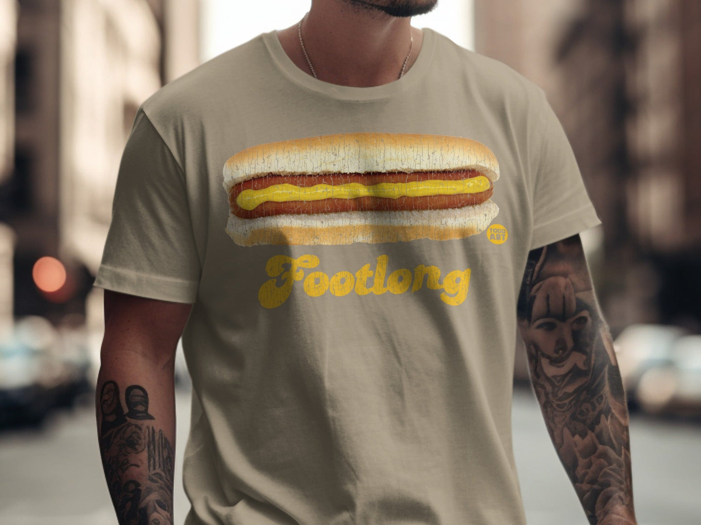 Tan t-shirt with a Footlong hot dog and mustard graphic.