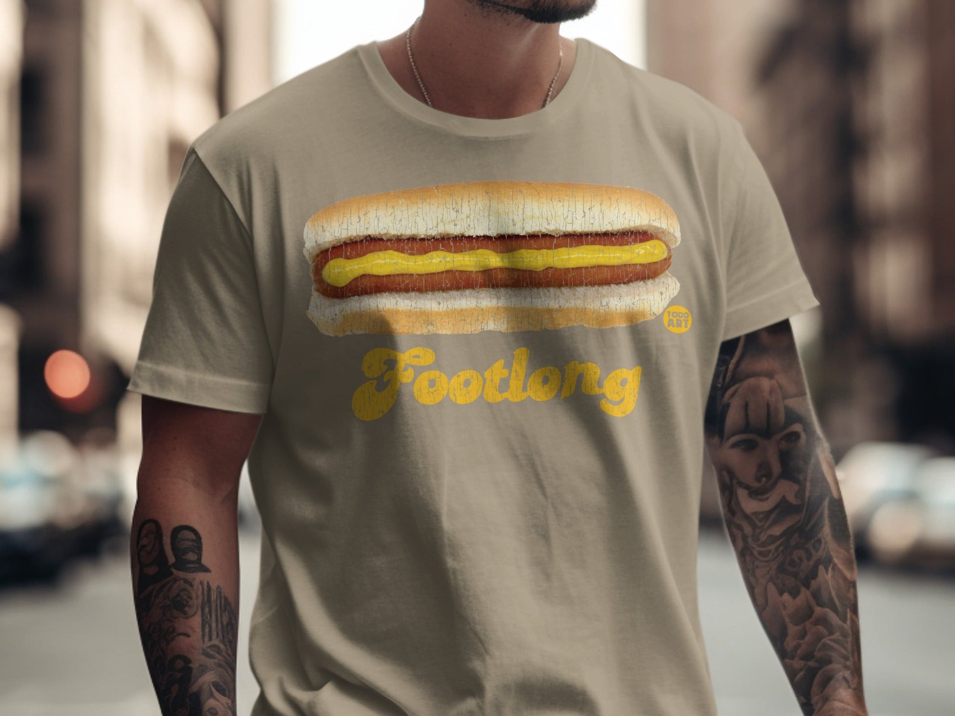 Tan t-shirt with a Footlong hot dog and mustard graphic.
