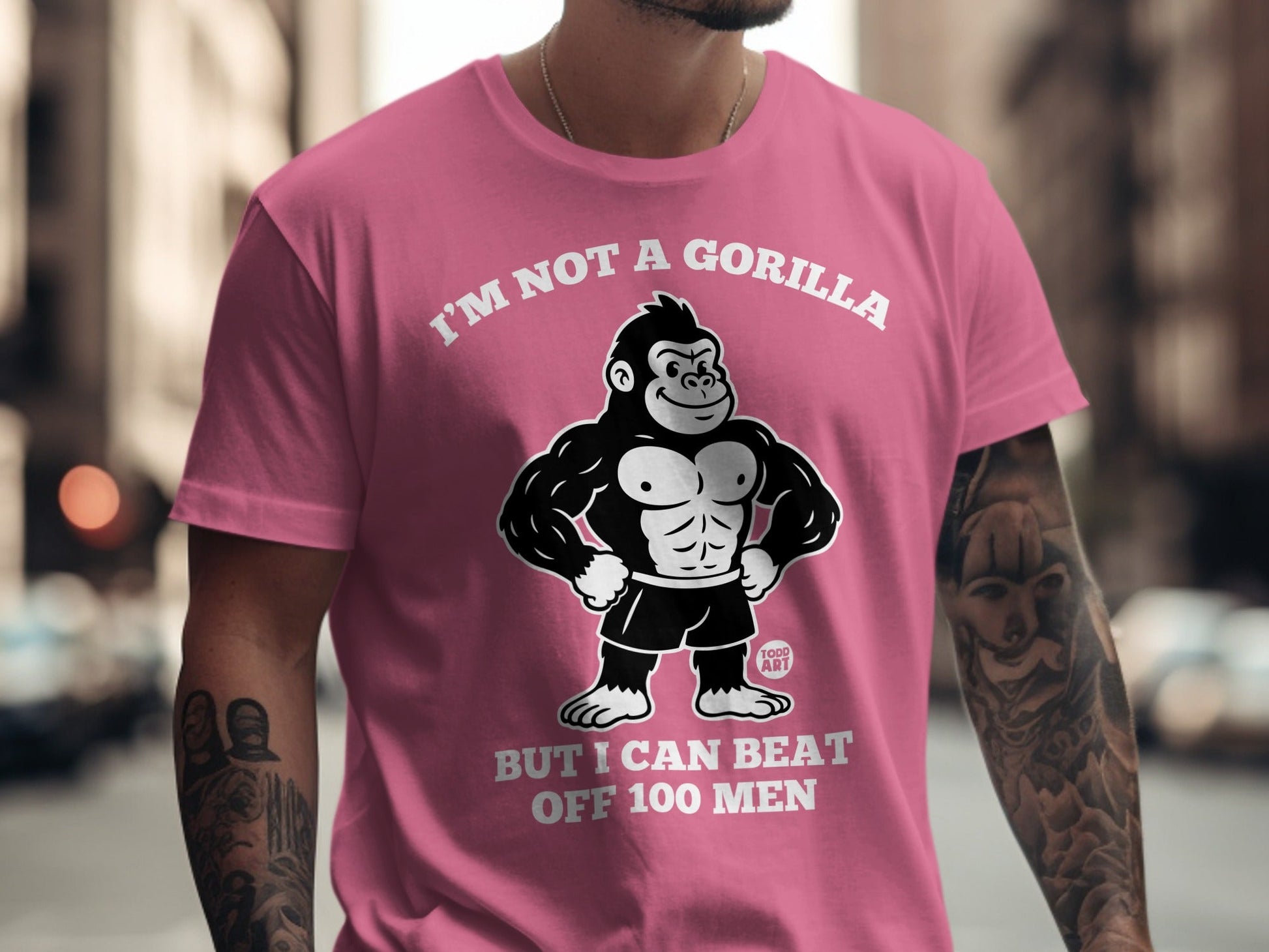 Pink t-shirt with gorilla graphic and text "I'm not a gorilla but I can beat off 100 men".