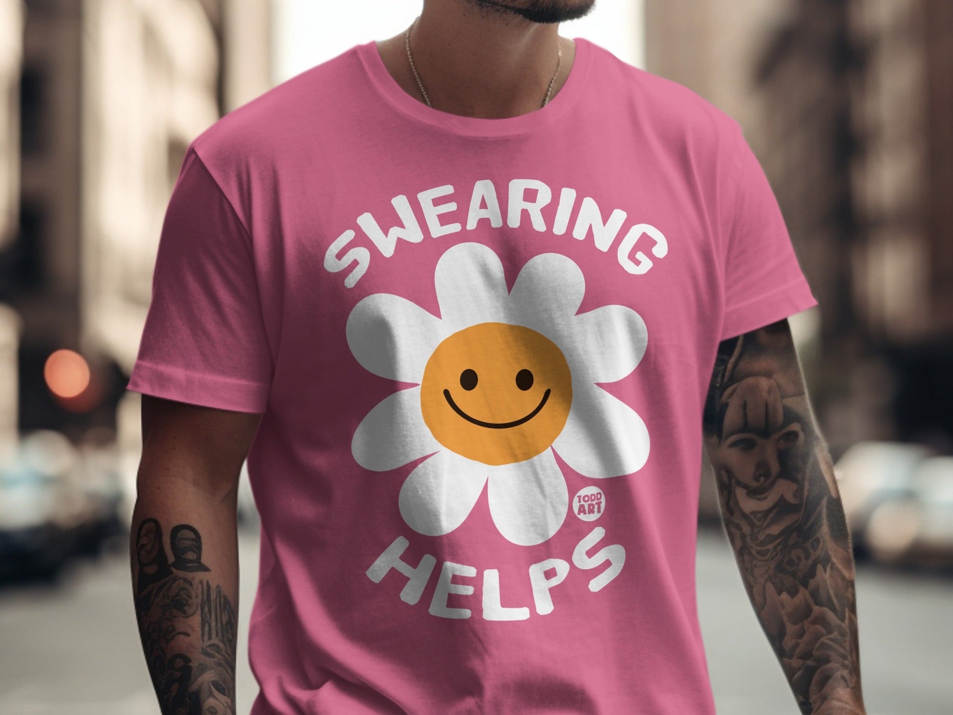 Pink t-shirt with "SWEARING HELPS" and a smiling flower graphic.