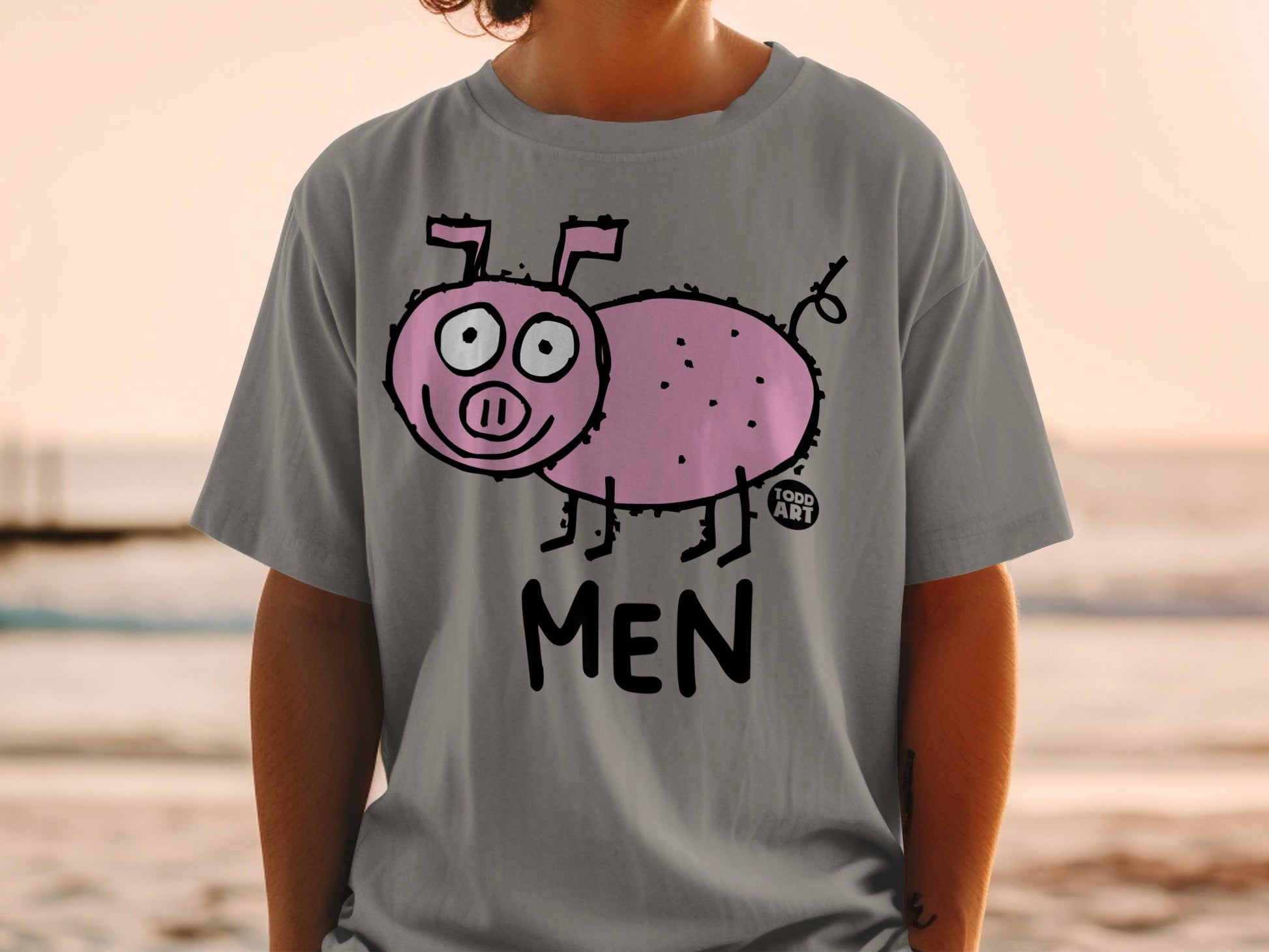 Gray t-shirt with a cartoon pink pig illustration and "MEN TODD ART" text.