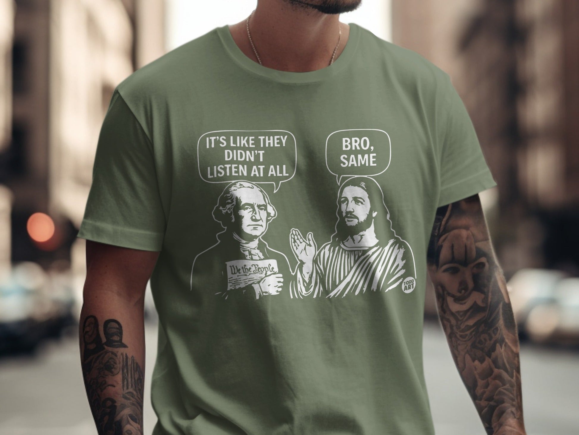 T-shirt graphic with Washington and Jesus figures discussing "We the People" with dialogue bubbles.