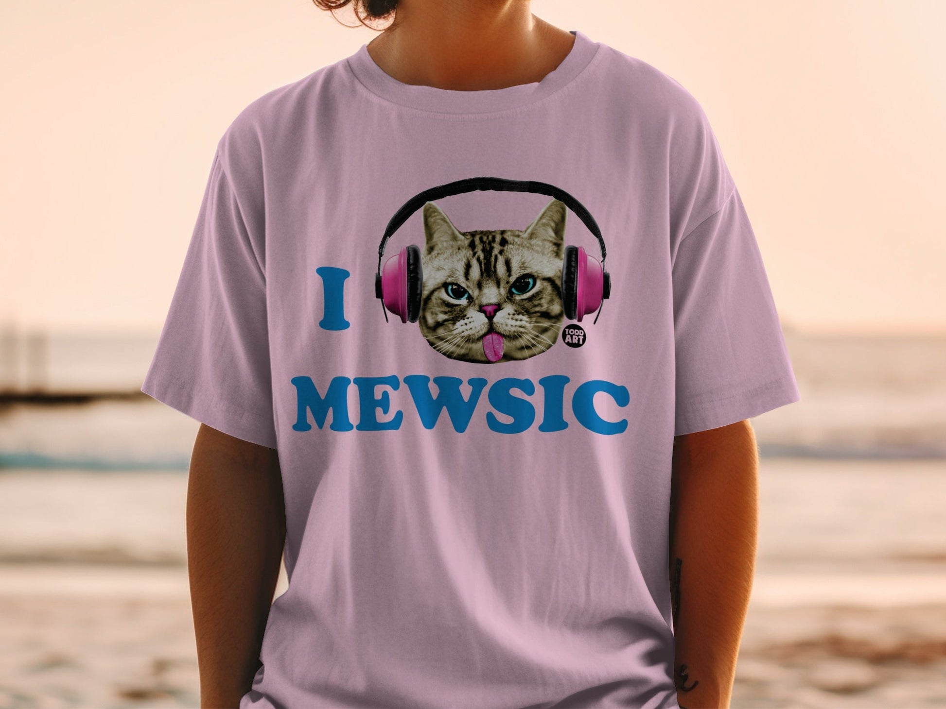 Pink t-shirt with cat wearing headphones and "I MEWSIC" text.