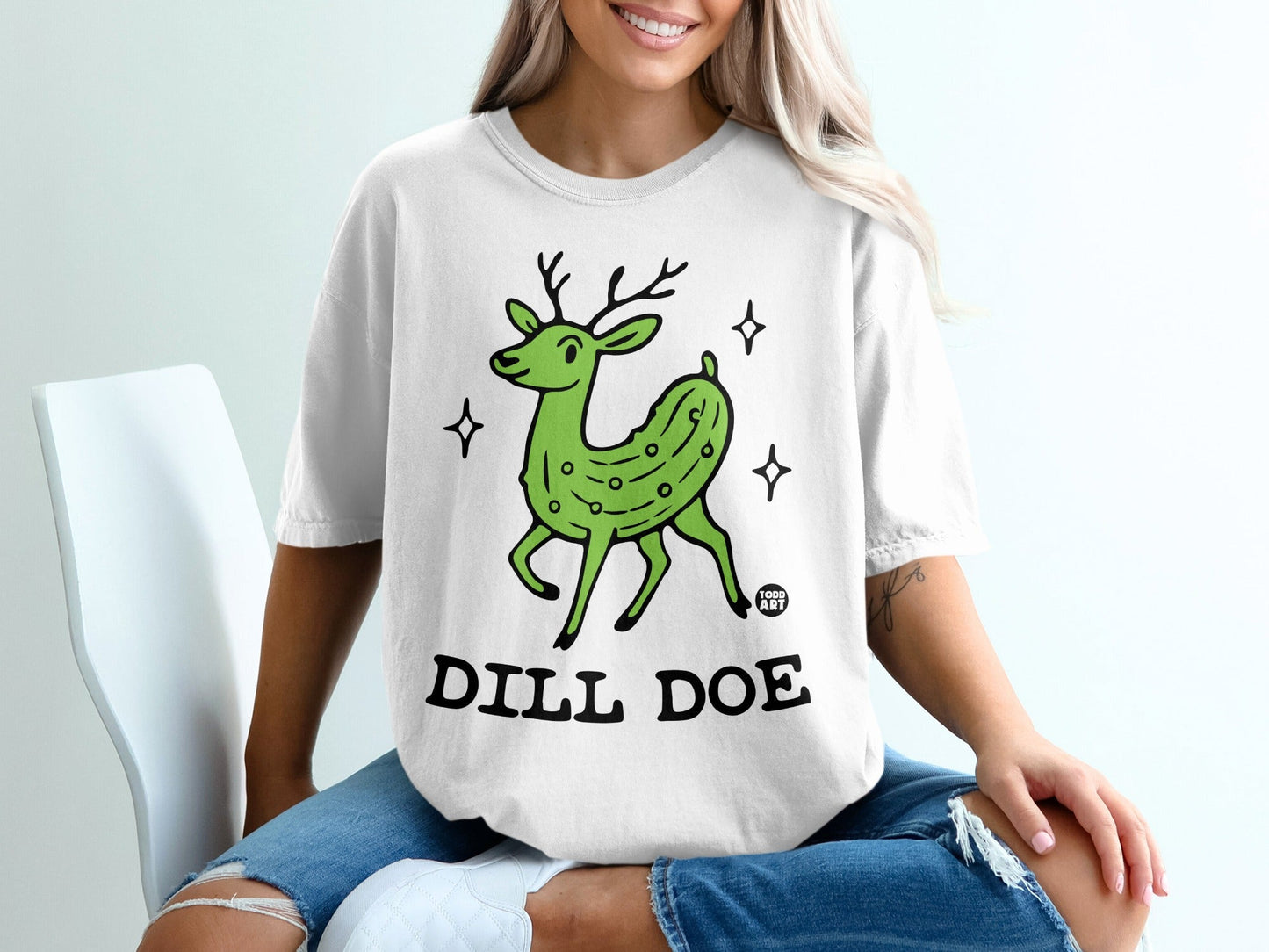 White t-shirt with cartoon green dill pickle deer and text "DILL DOE".