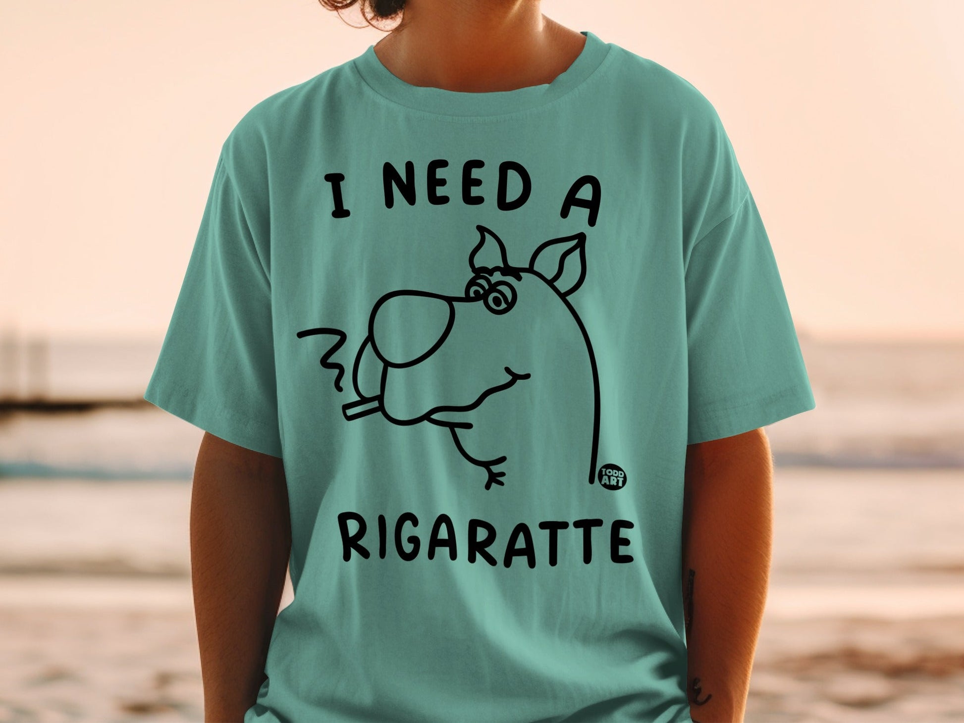 Teal t-shirt with Scooby-Doo silhouette smoking, text "I need a rigarette".